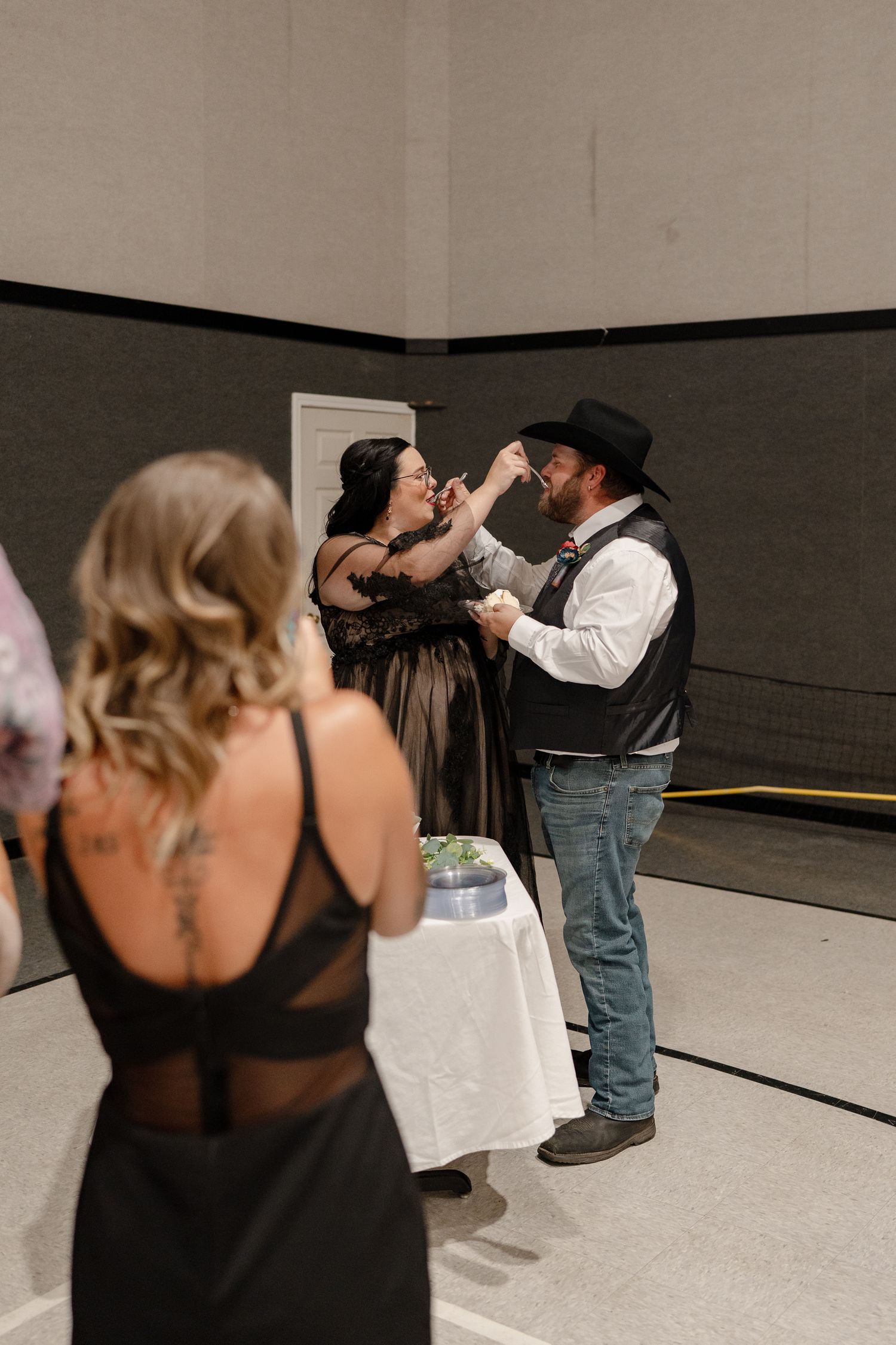 Couples dance together in a casual indoor setting with a minimalist backdrop.