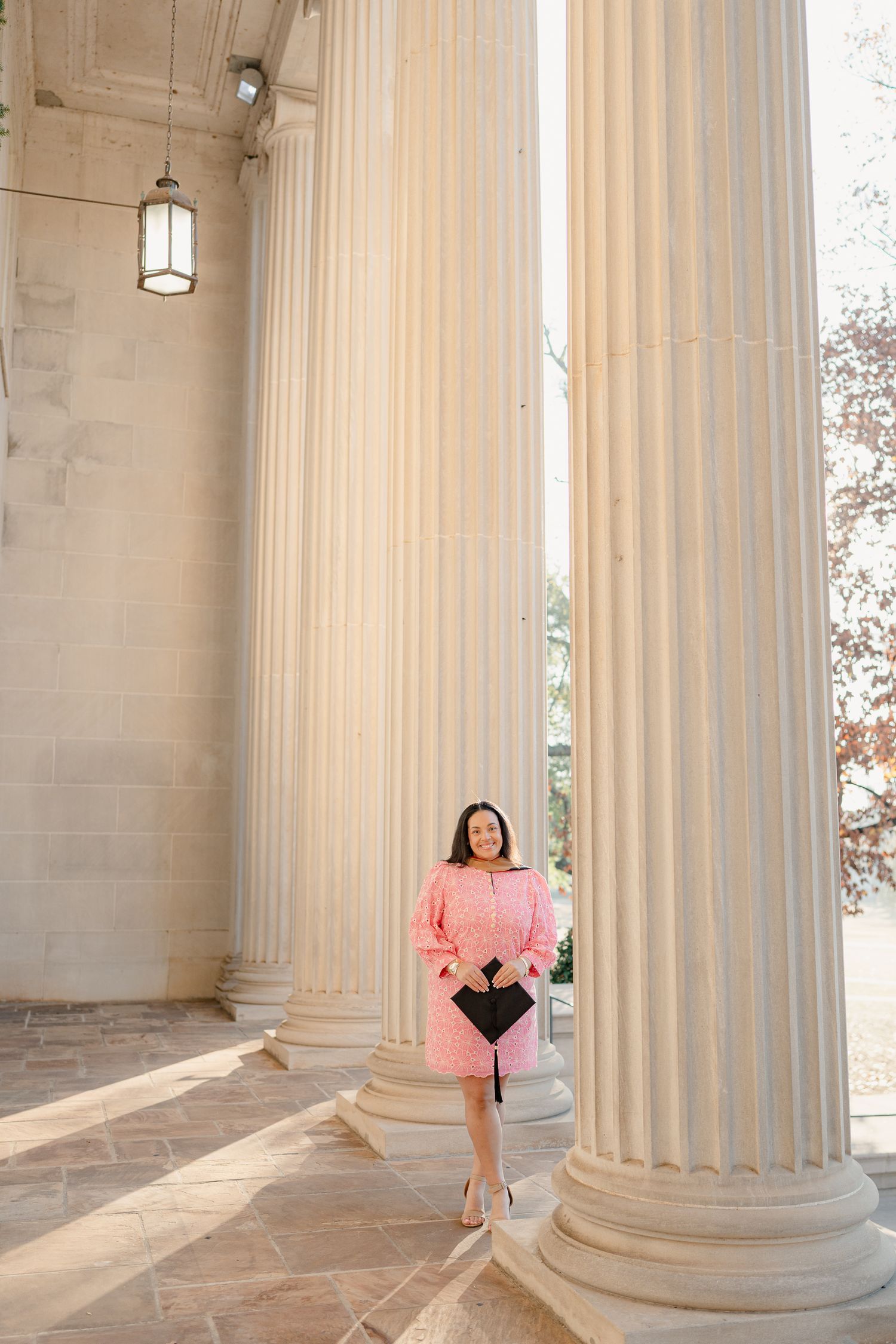 Graduation photo series featuring classical white columns and elegant architecture.