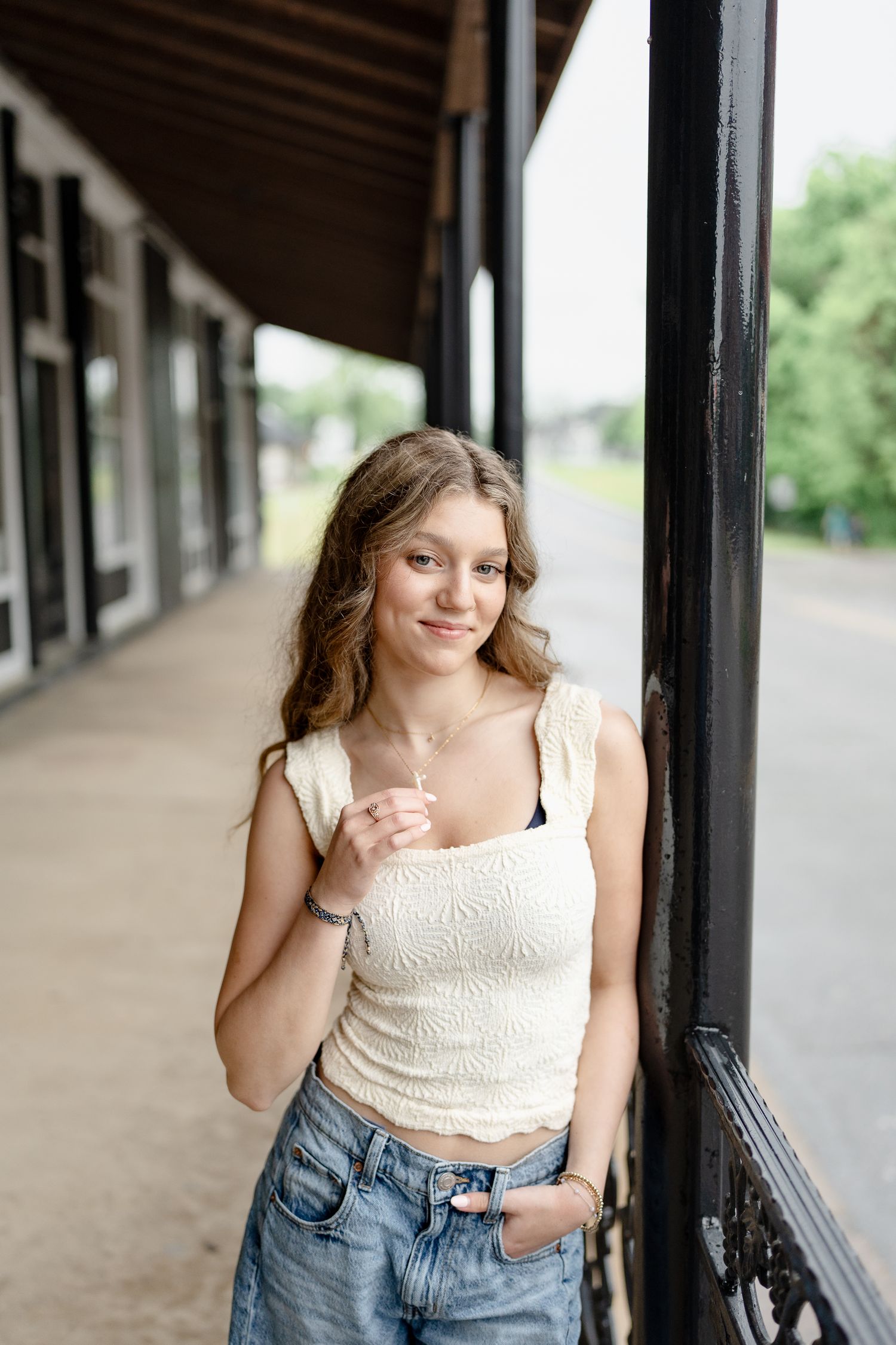 Relaxed fashion poses against a rustic architectural backdrop with natural lighting.