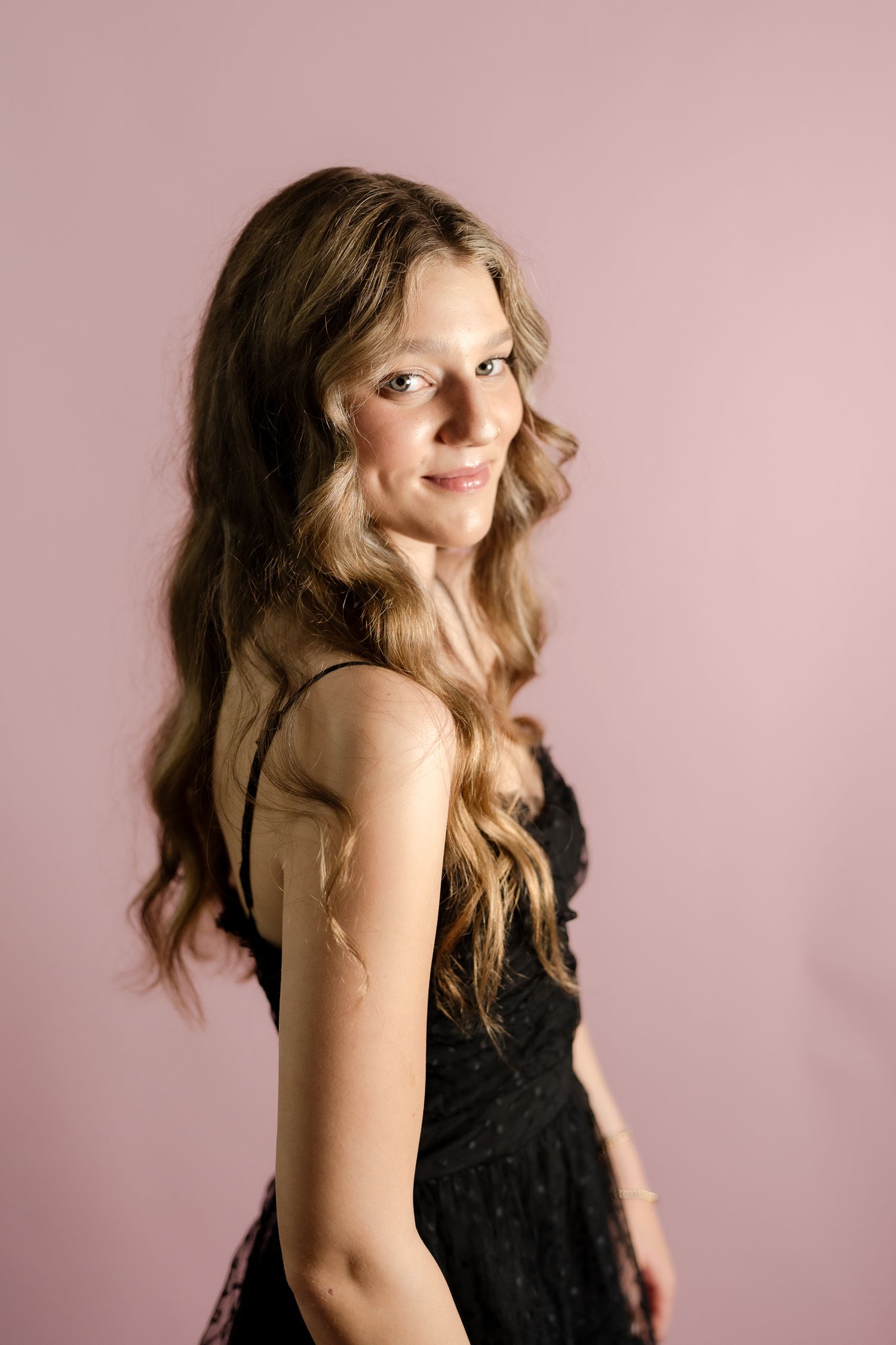 Fashion portraits feature a black dress in dramatic poses against a pink studio backdrop.