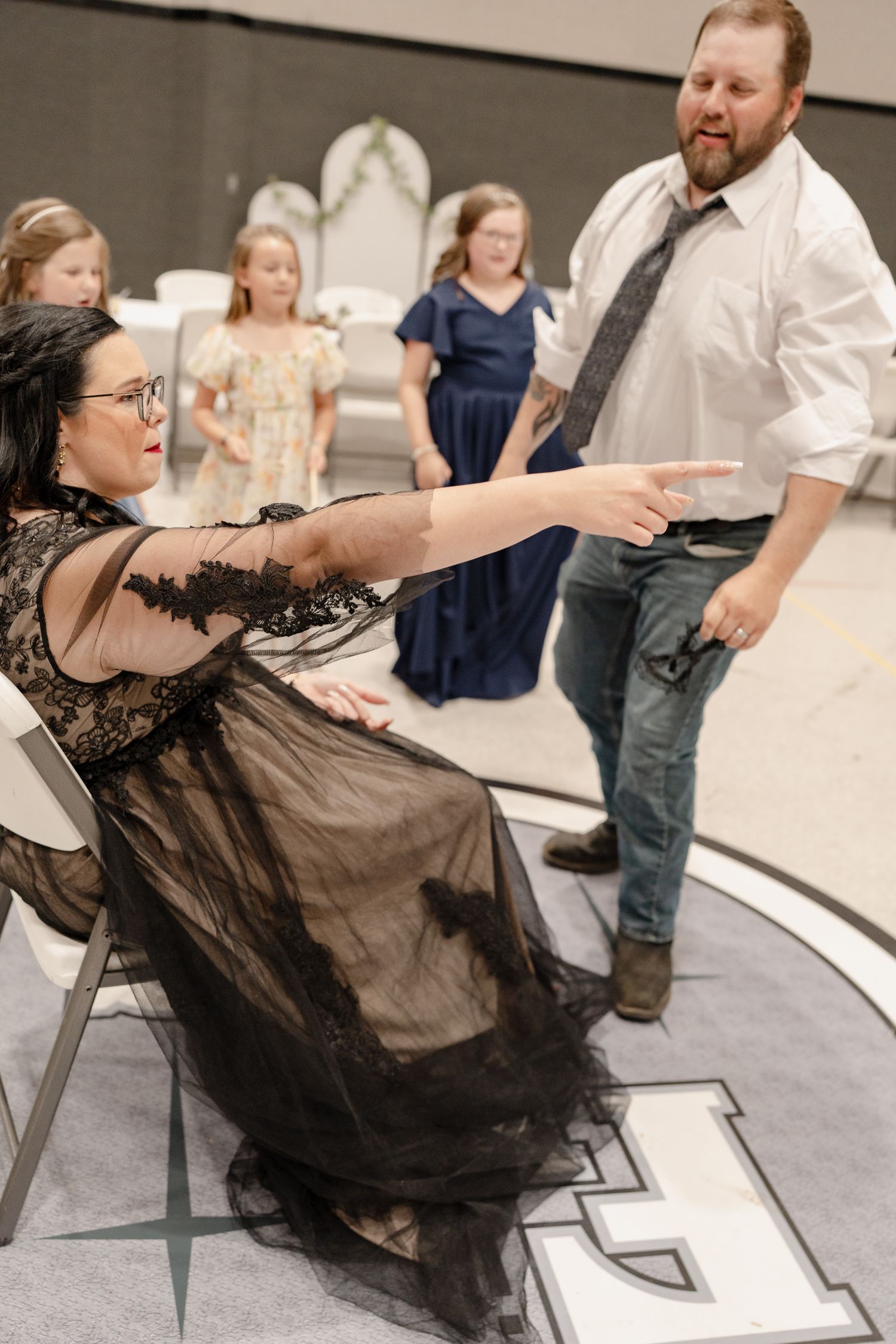 A sequence of images shows someone falling backwards off a chair in a dramatic fashion during what appears to be a performance.