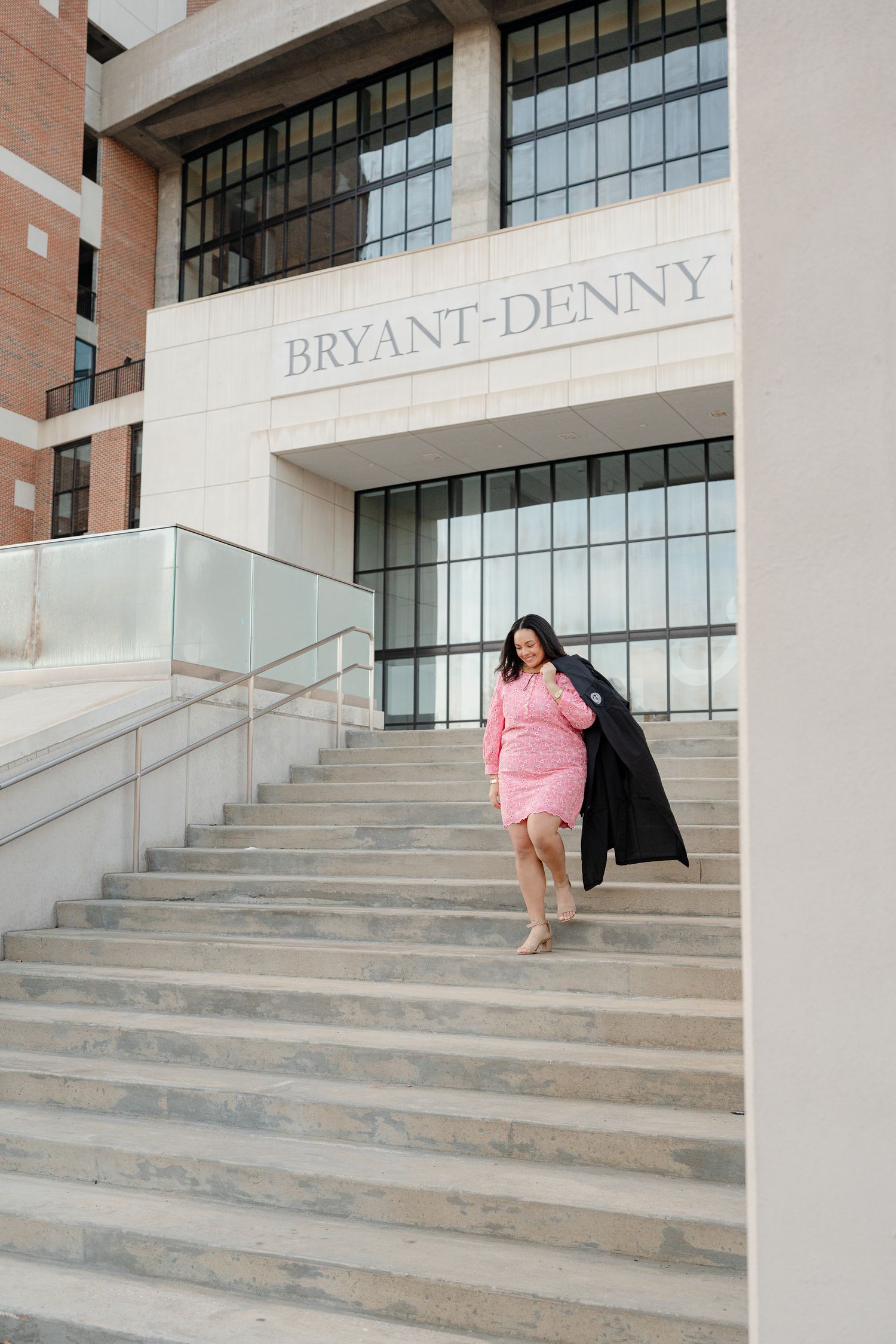 A sequence of photos showing a graduate in pink dress and black gown posing on concrete steps at Bryant-Denny Stadium.