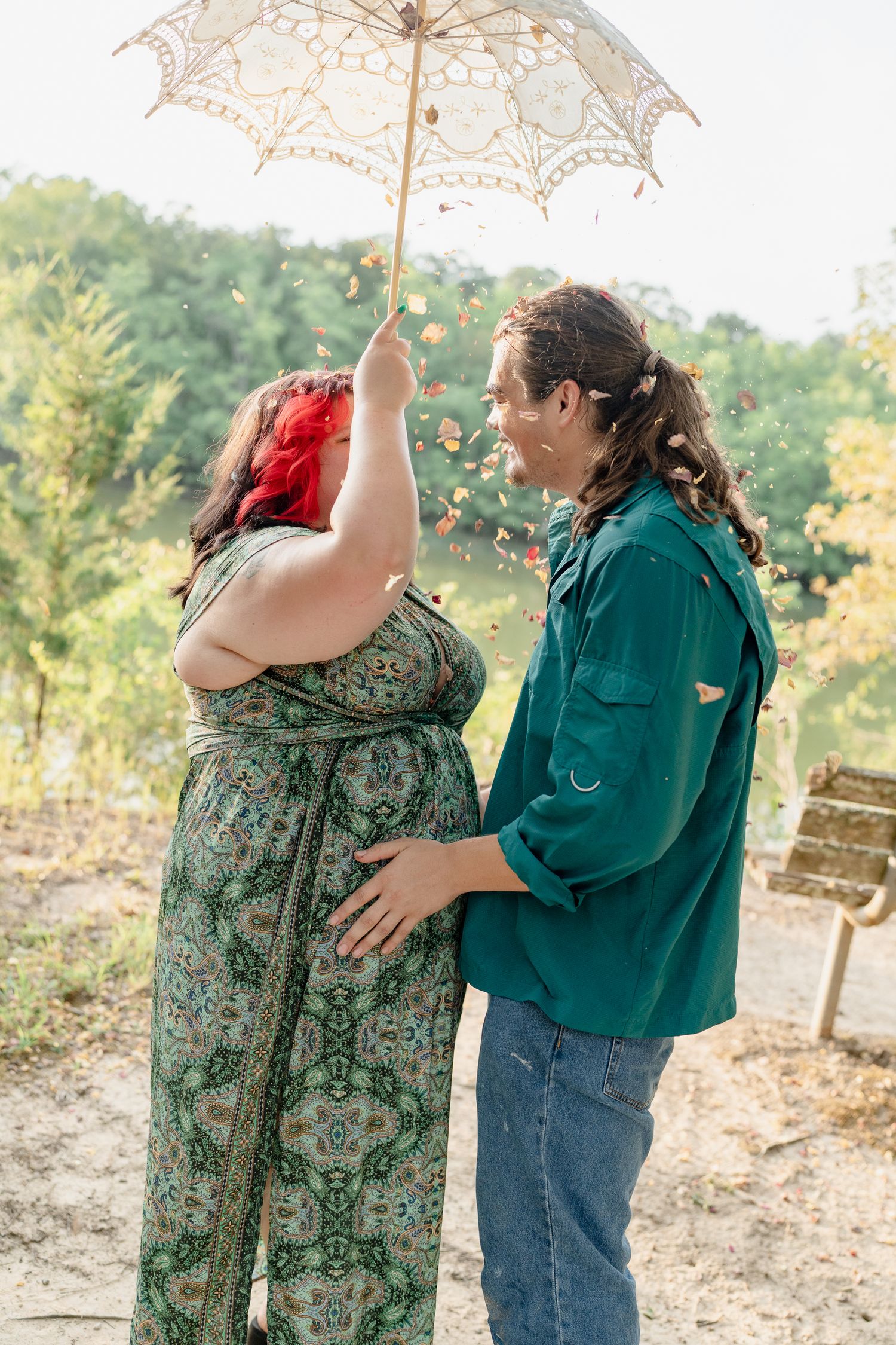A series of romantic photos showing a couple embracing under a delicate white parasol in a rustic outdoor setting.