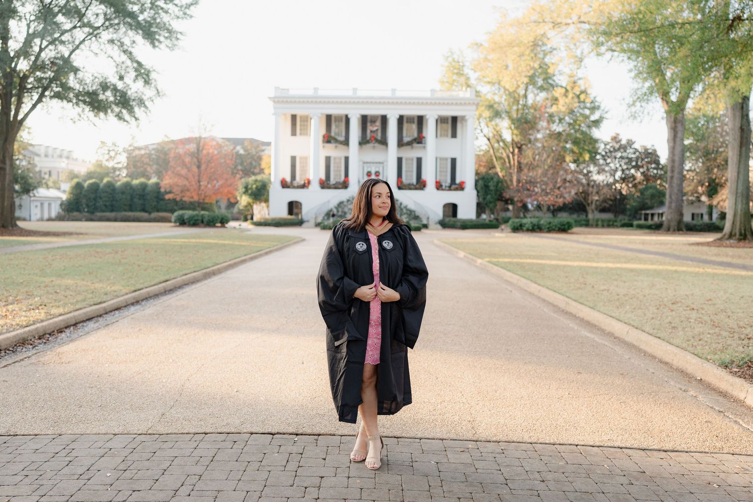 A series of outdoor photos showing someone in a pink dress and black jacket walking and posing on a brick pathway.