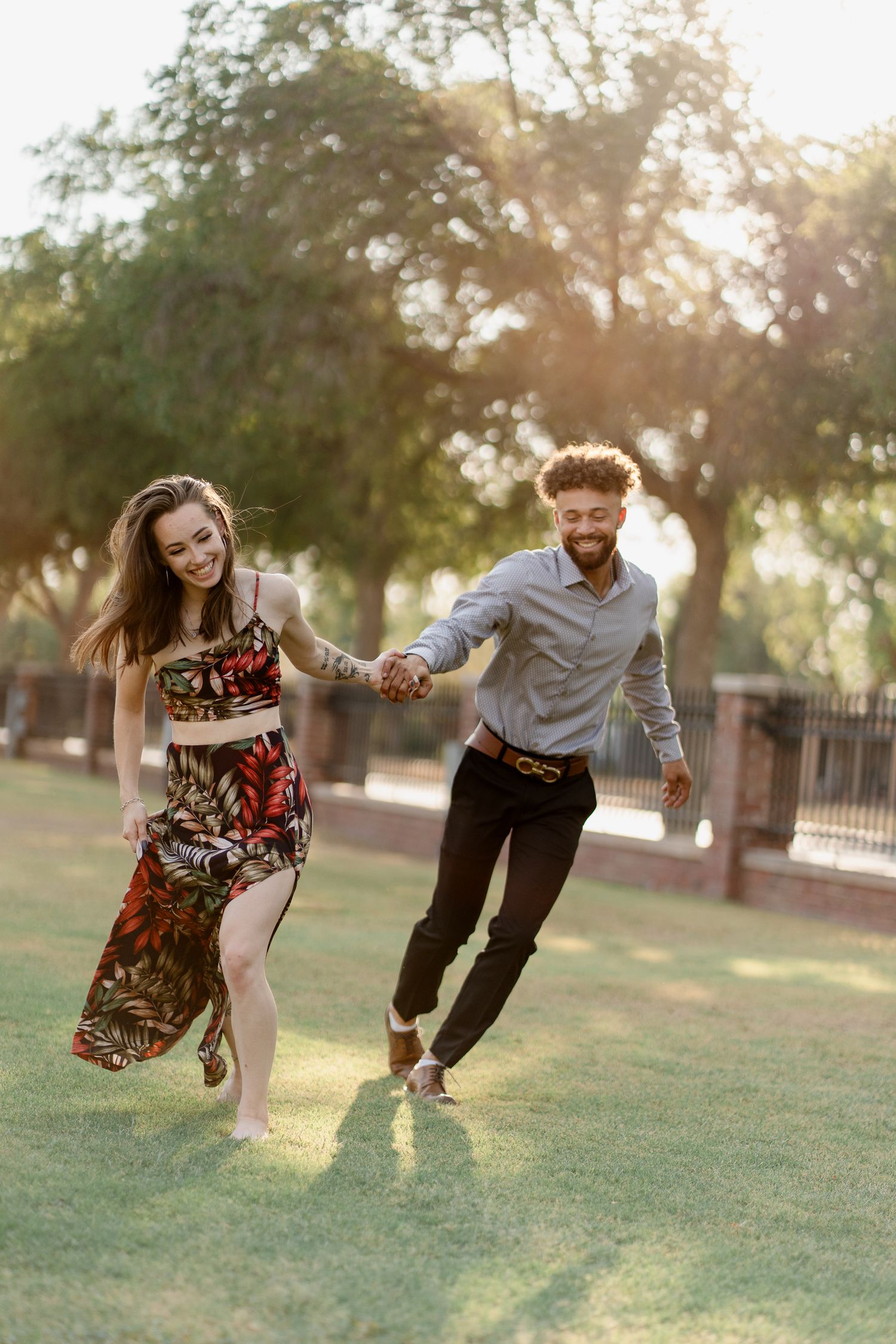 Playful outdoor photoshoot with people doing creative jumping poses in a park.