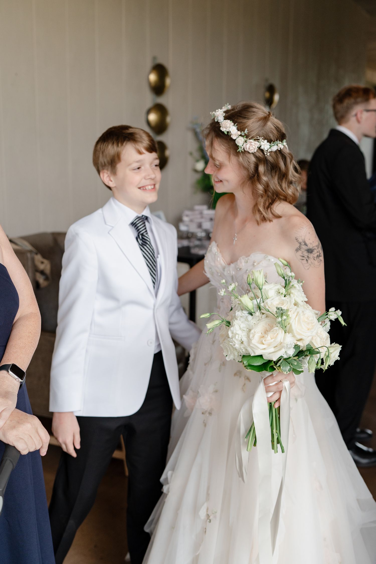 Children in formal attire dancing together at an elegant wedding reception.