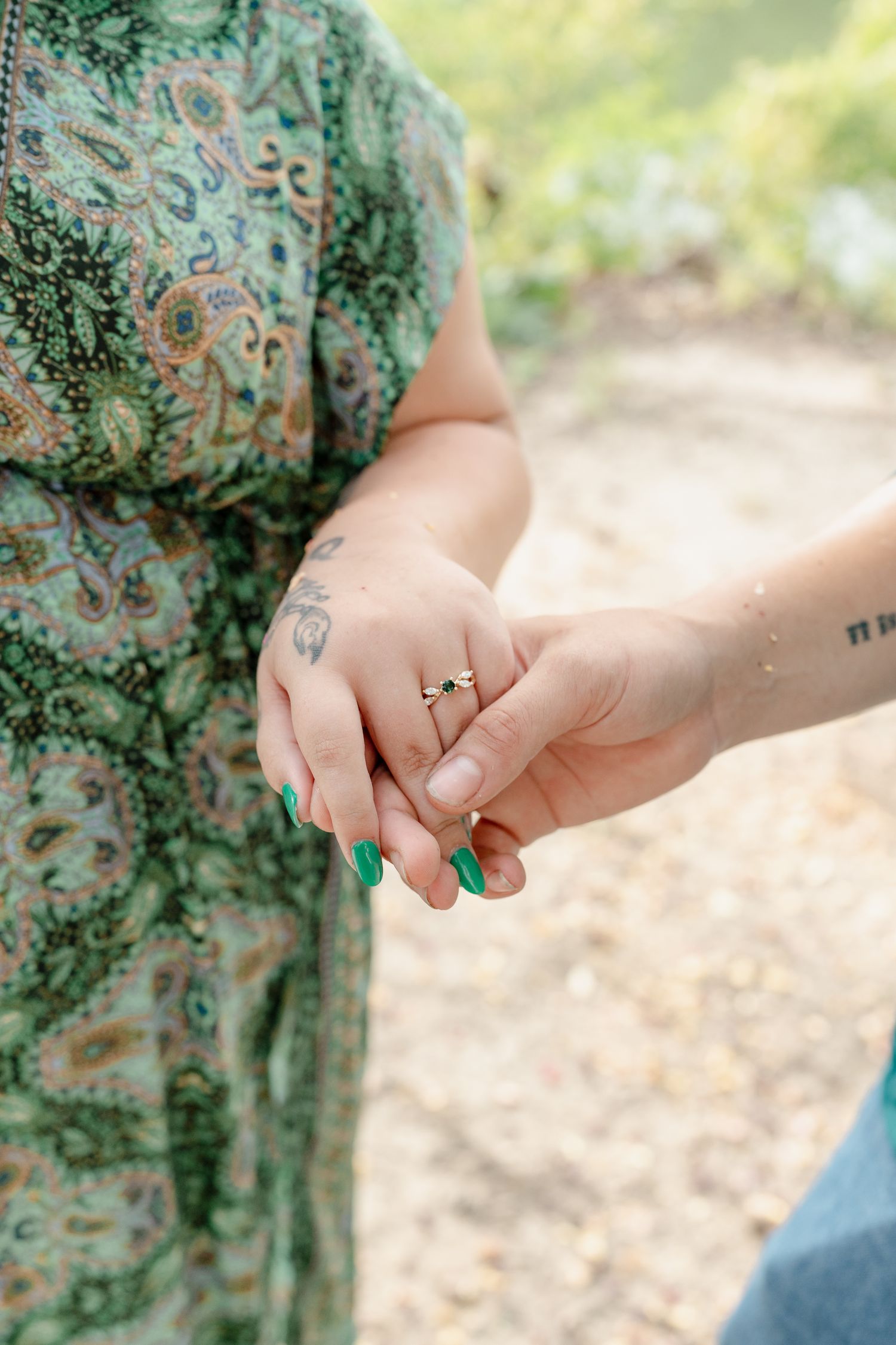 Close-up shots of hands showing off rings and jewelry during an outdoor photoshoot.