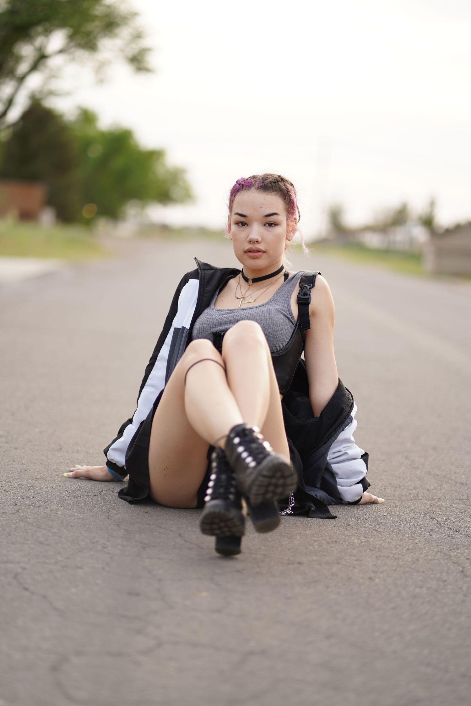 Urban fashion shot showcasing black and white athletic wear and combat boots on pavement.