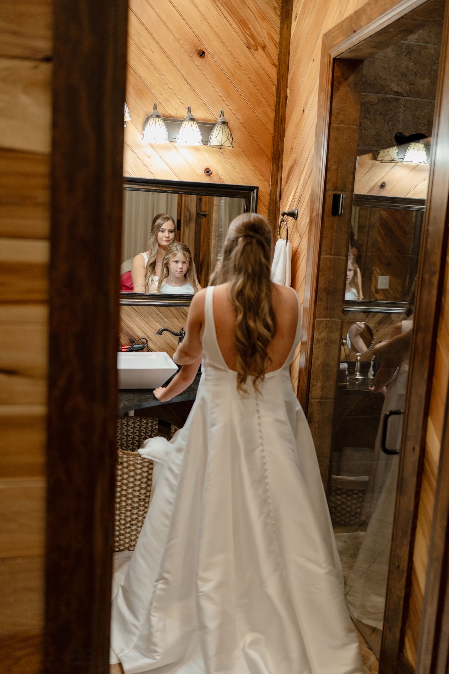 A series of wedding dress shots showing the back buttons and details in a rustic wooden interior.