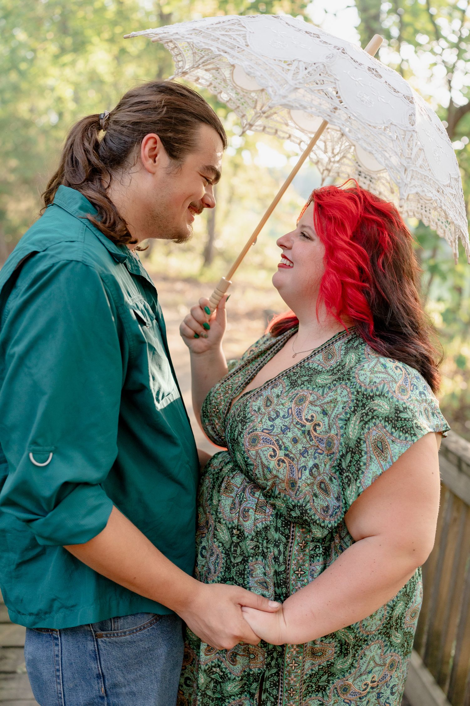A romantic couple shares tender moments under a lace parasol in a garden setting across four progressive photos.