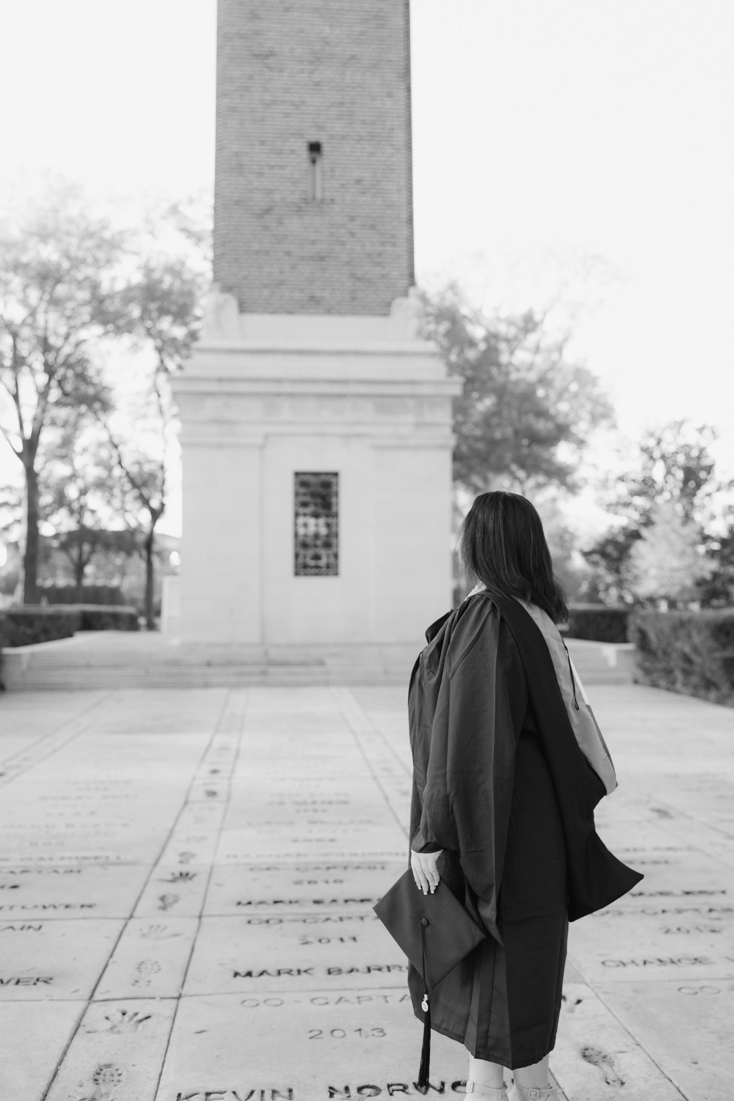 Black and white photos of a graduate in cap and gown near architectural steps.