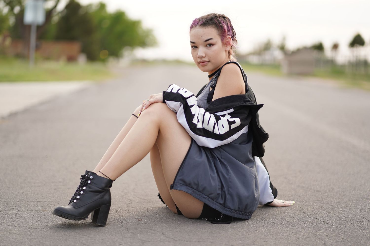 Street style photo featuring black and white sportswear and chunky boots on pavement.