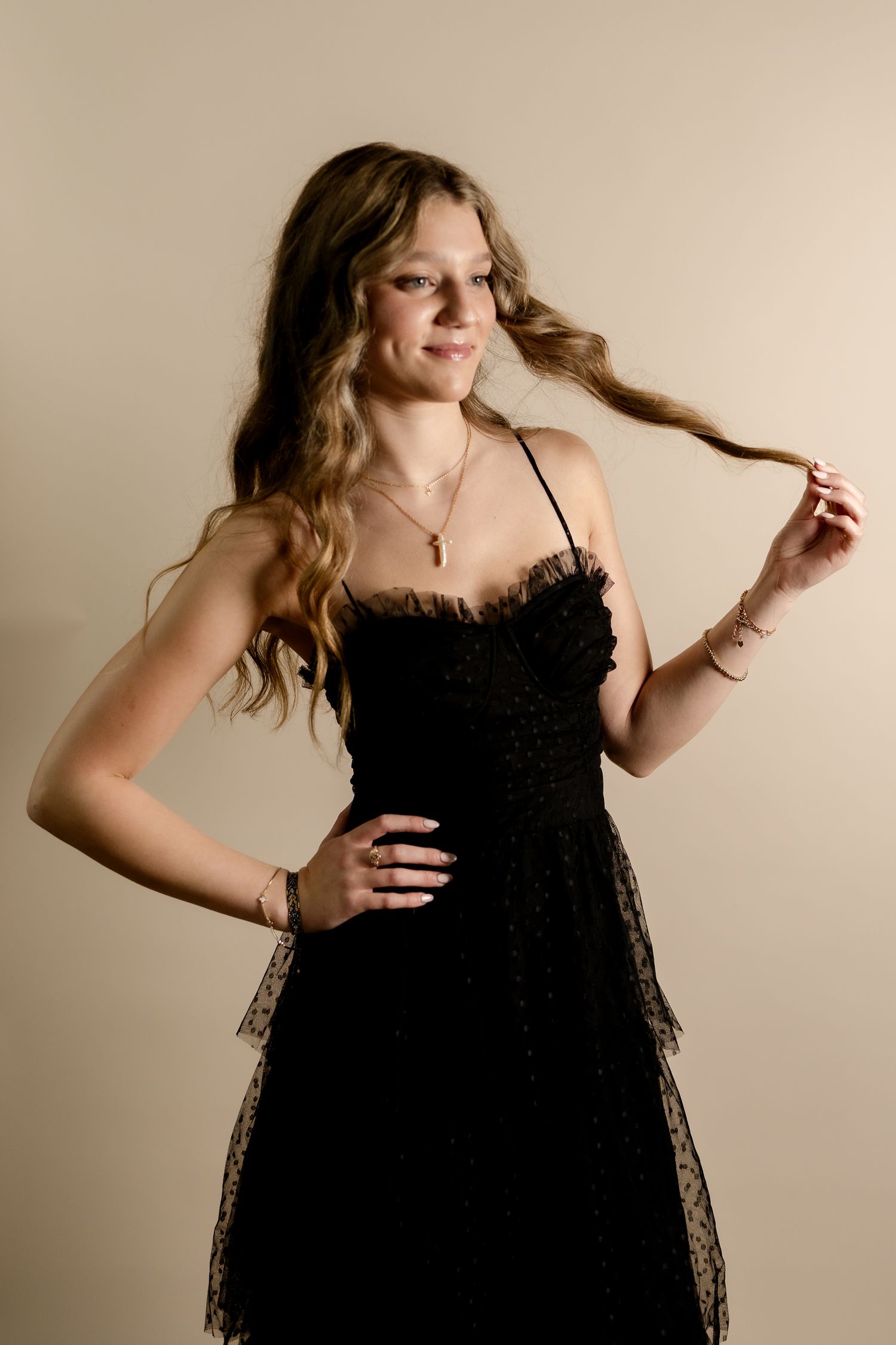 Model in black lace dress shows movement through dynamic poses.