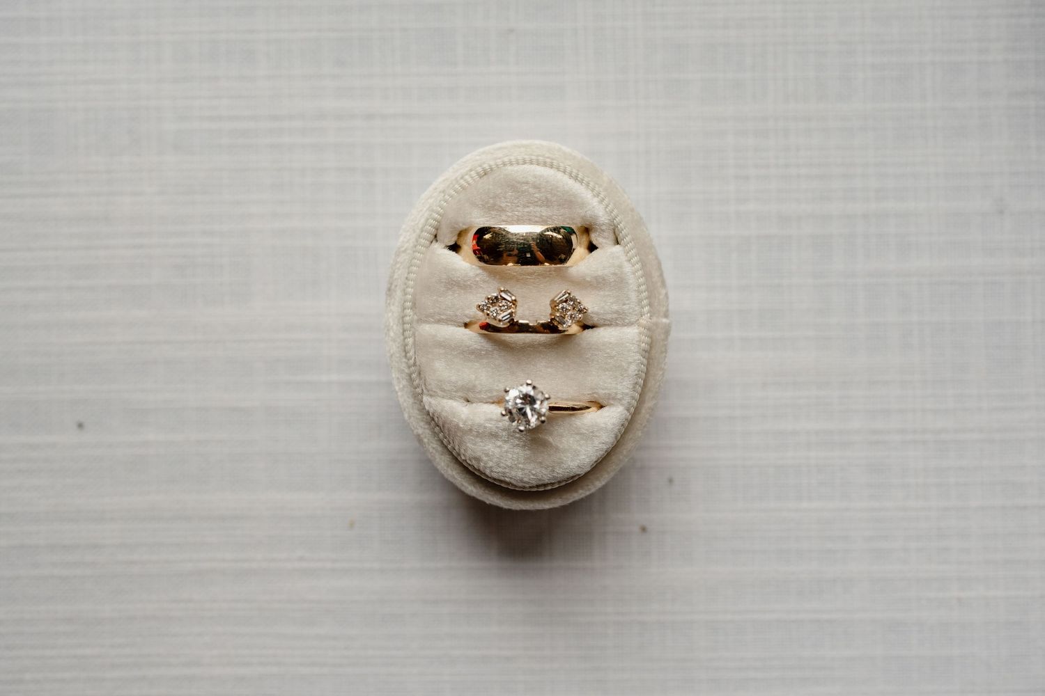 A series of six close-up photographs showing a white ring box opening to reveal a sparkling engagement ring.