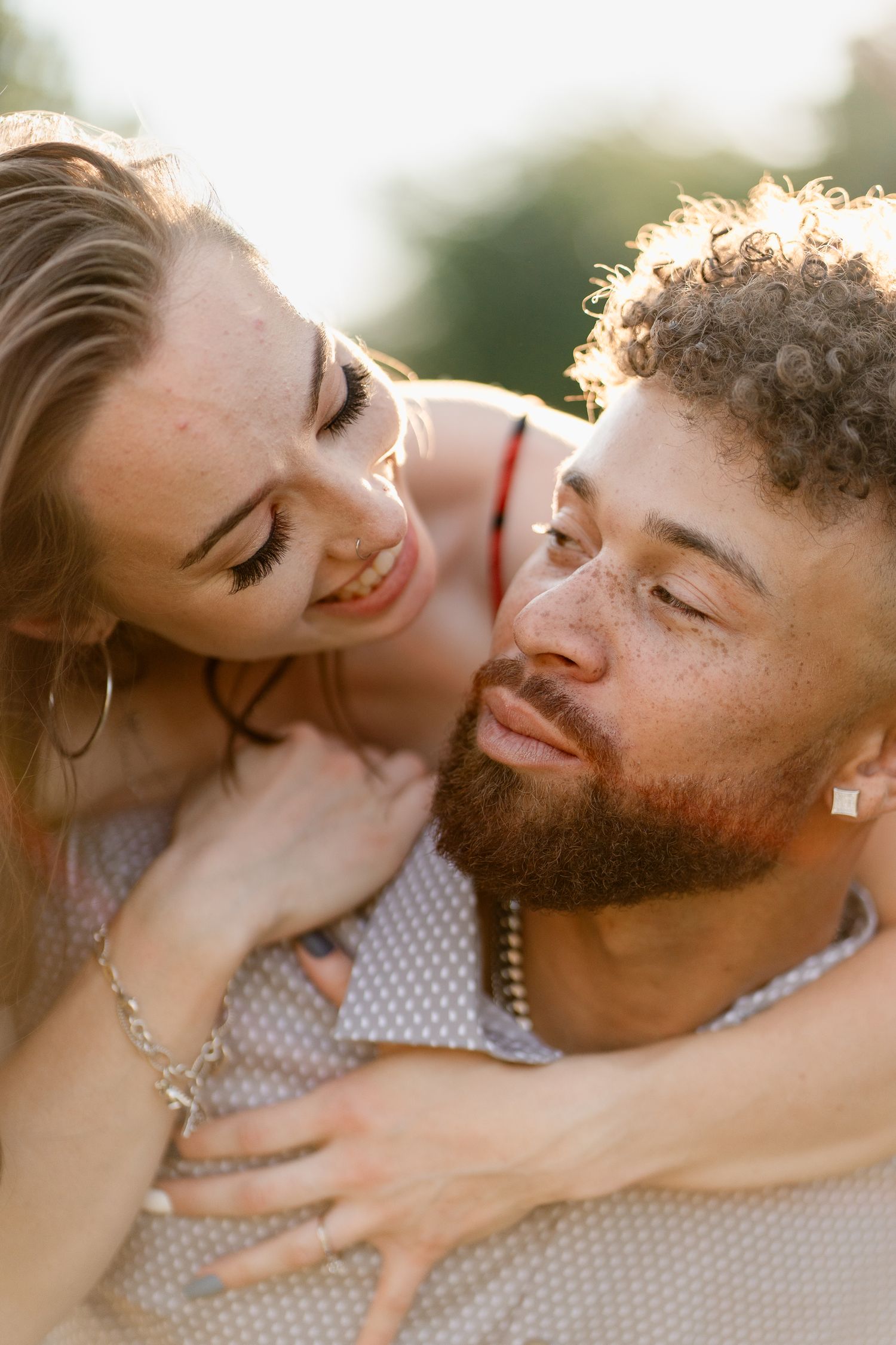 An intimate couple shares tender moments during golden hour photography session.