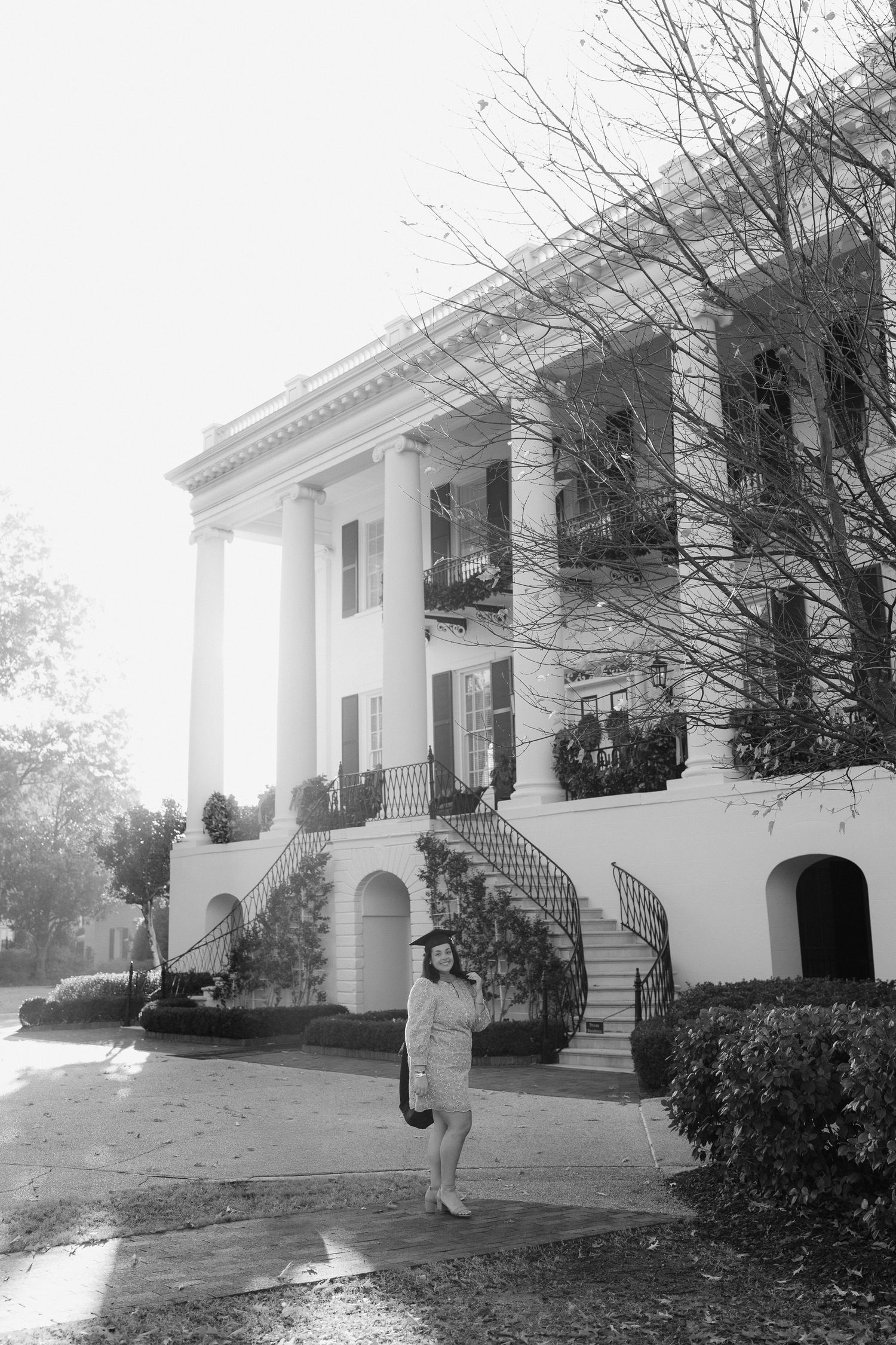 A series of black and white photos showing dance movements in front of a white colonial building.