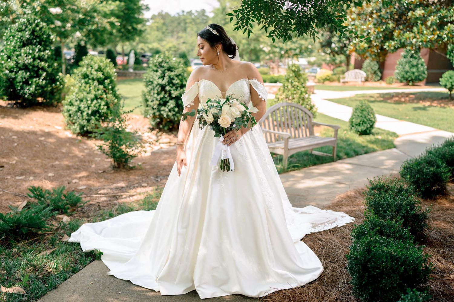 Elegant wedding scene in a lush garden setting with flowing white dress and natural greenery.