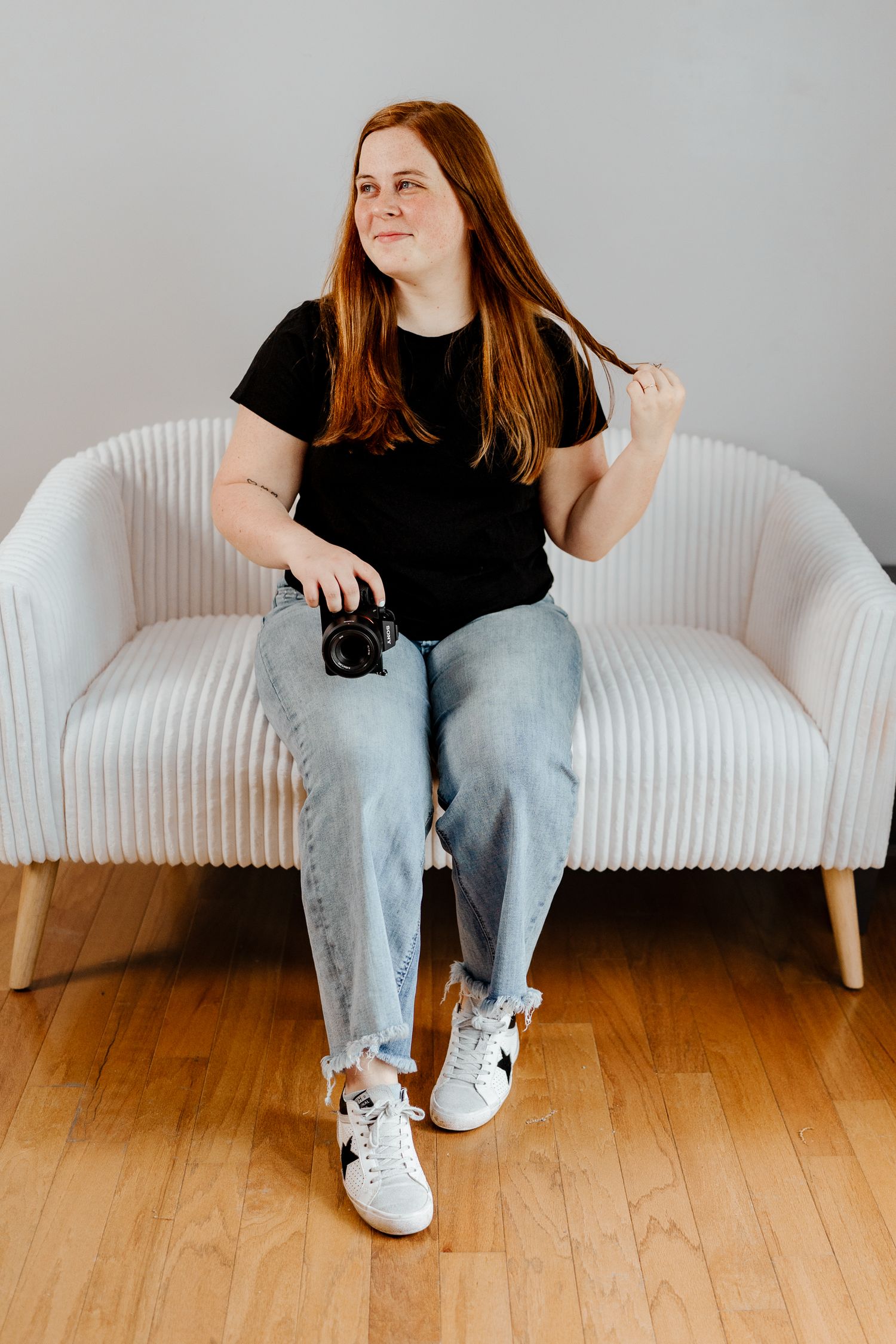 Relaxed lifestyle portraits on white modern sofa showing natural poses and expressions.