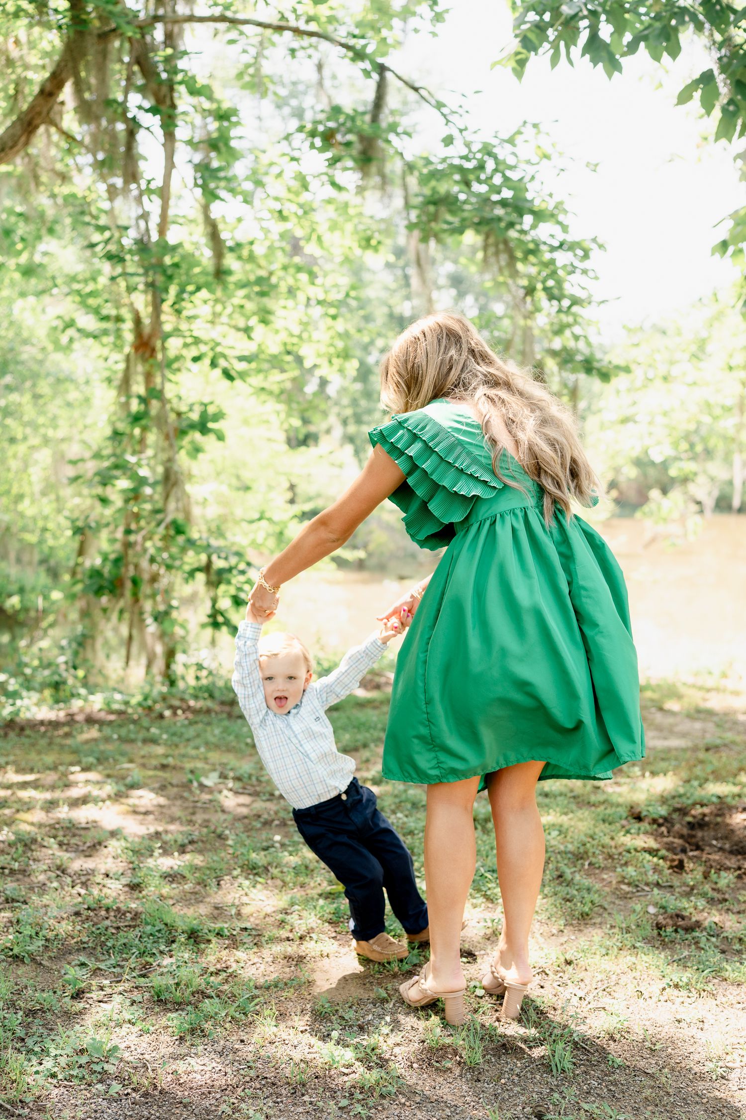 Candid moments of play captured in a forest setting with green dress and casual attire.