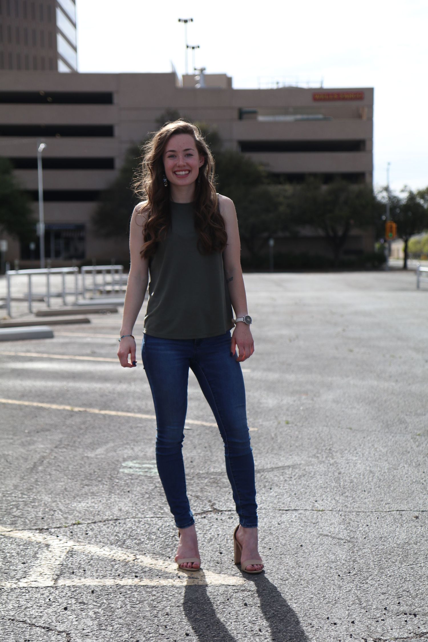Casual street style photography in an urban parking lot setting.