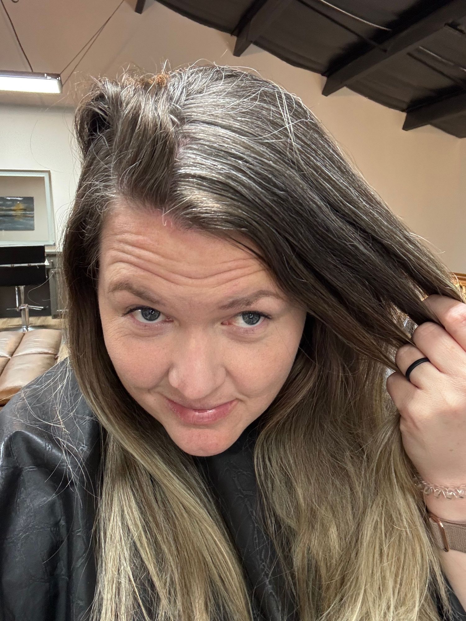 Close-up selfies showing long brown hair with blonde highlights in an indoor setting.