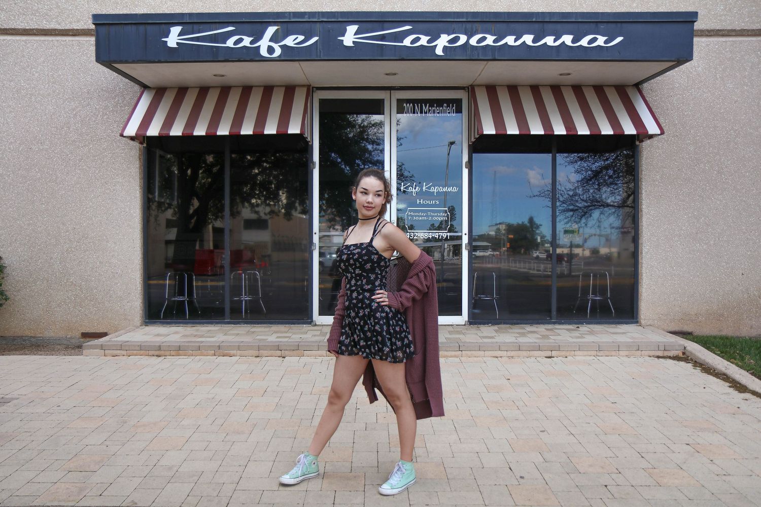 Storefront exterior of Cafe Esposana with striped awning.