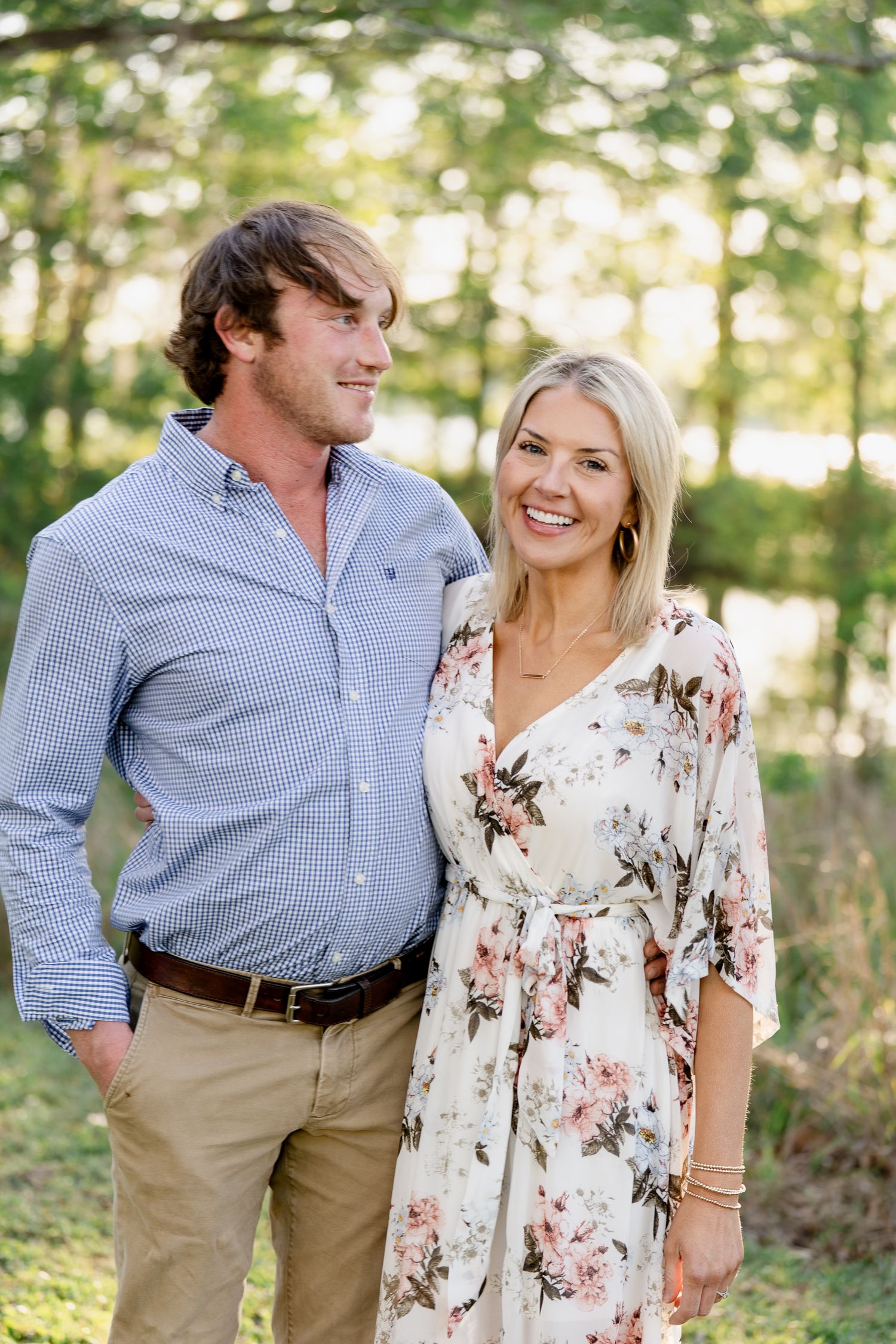 Candid couple shots in coordinated outfits against a lush green forest background.