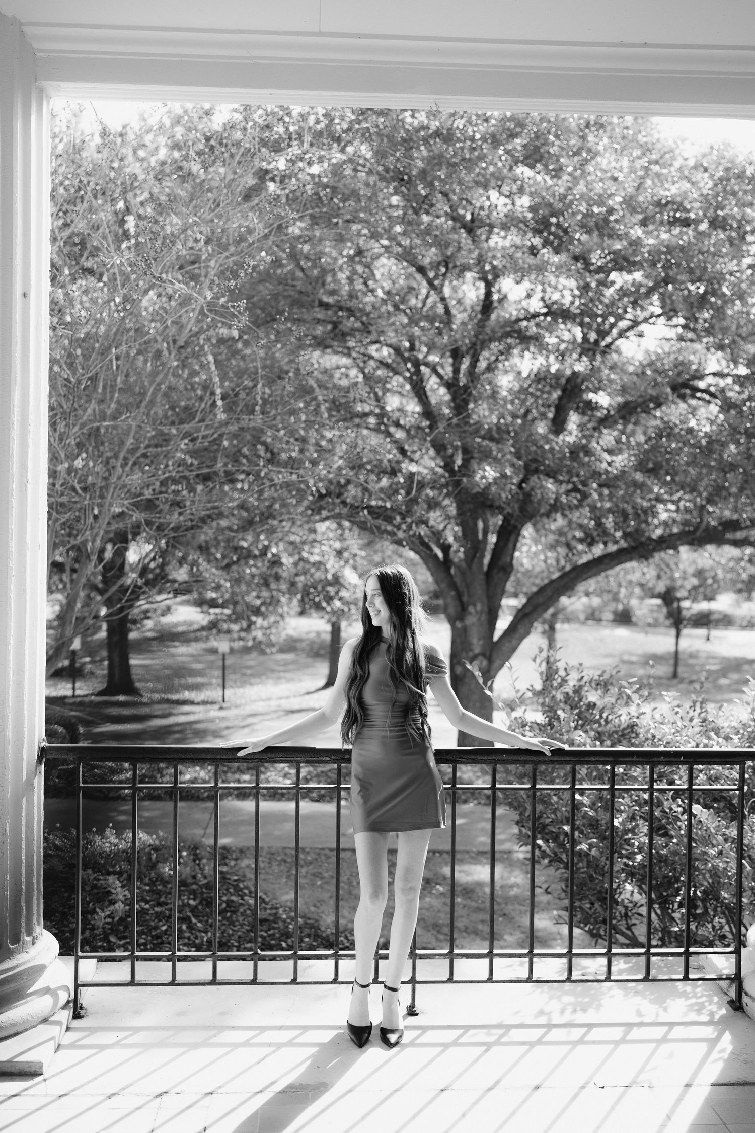 A black and white sequence of images showing a figure on a porch with trees in the background.