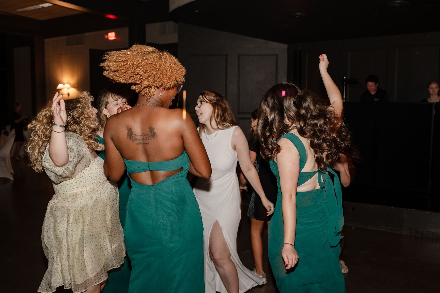Wedding reception dance floor with guests dancing in formal attire.