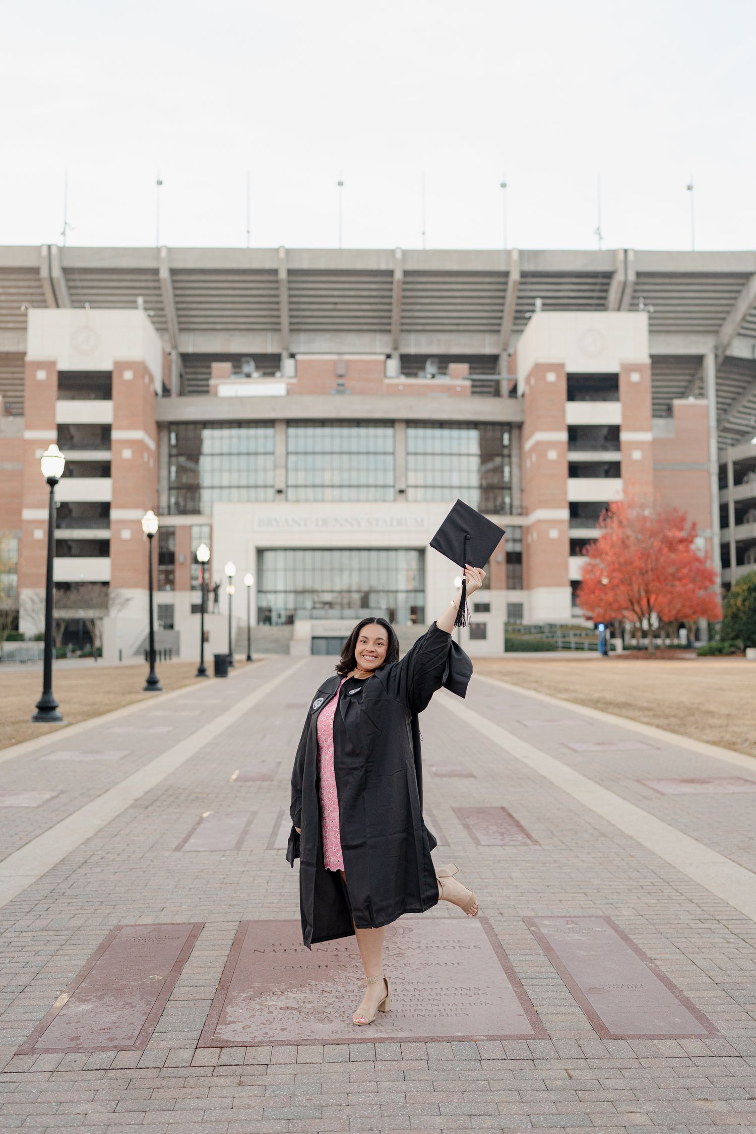 Celebratory graduation photo sequence showing joyful poses in front of a large stadium entrance.