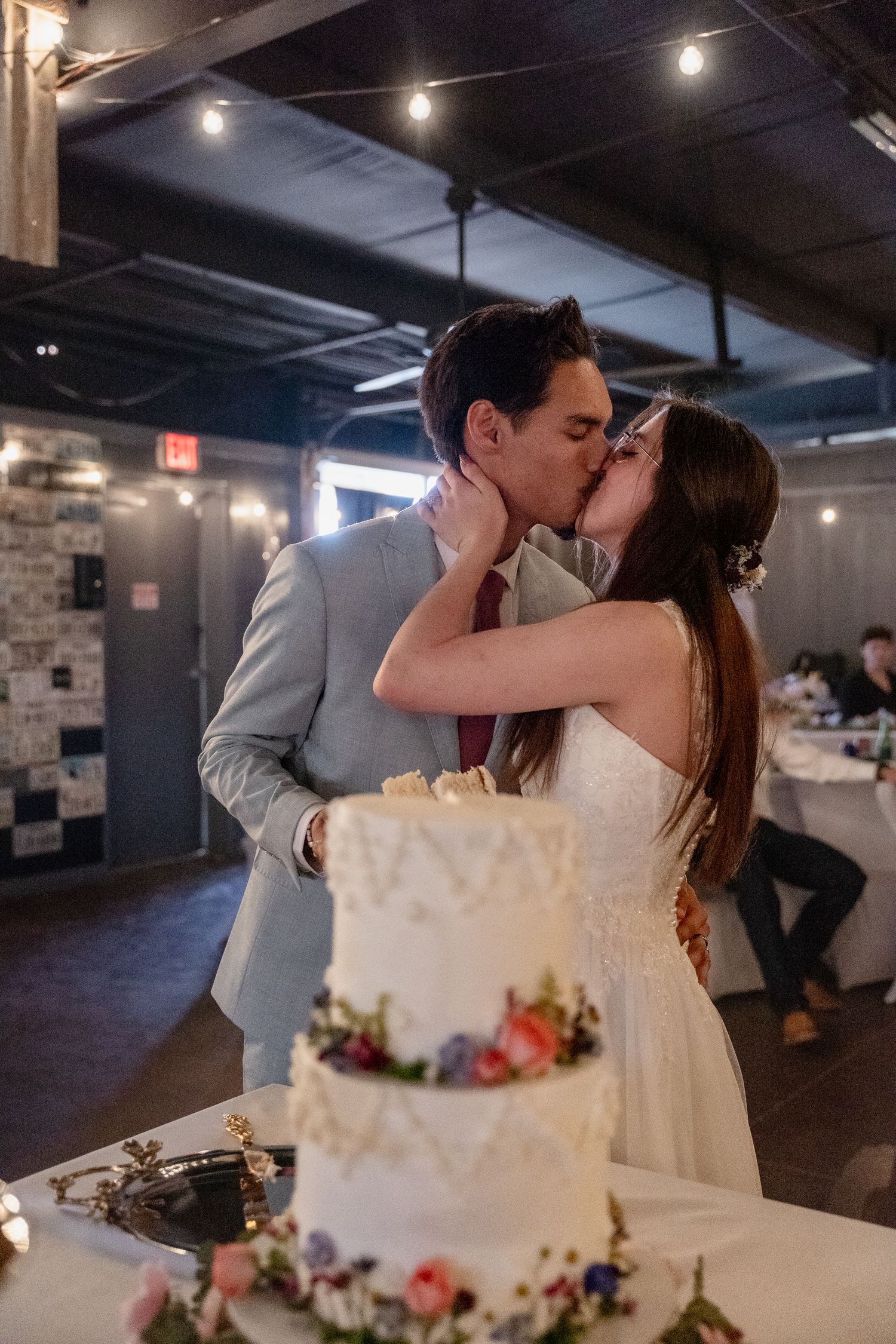 A romantic wedding cake cutting sequence shows the newlyweds sharing a sweet moment at their reception.