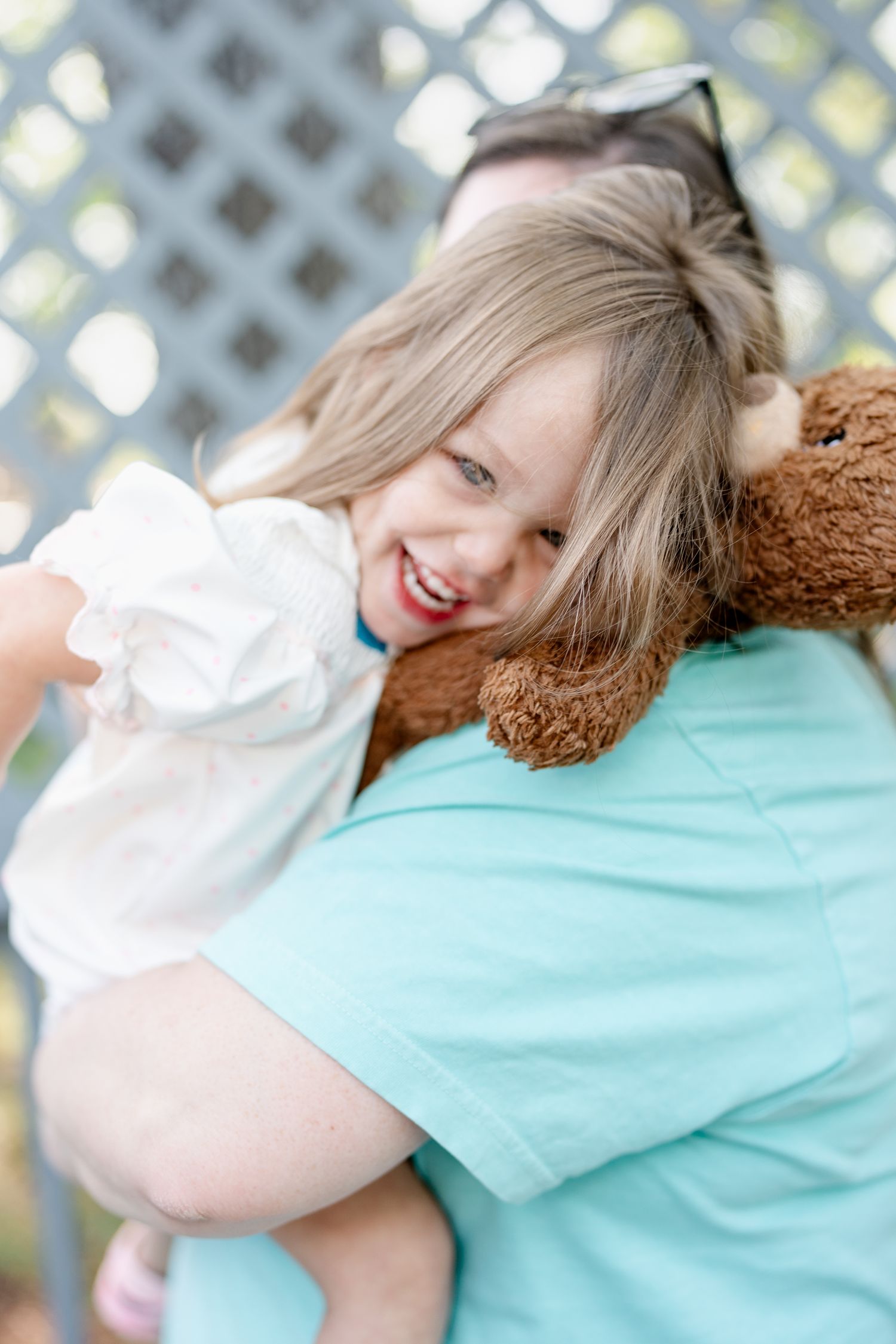 Sweet moment of cuddles with a soft teddy bear and turquoise shirt.