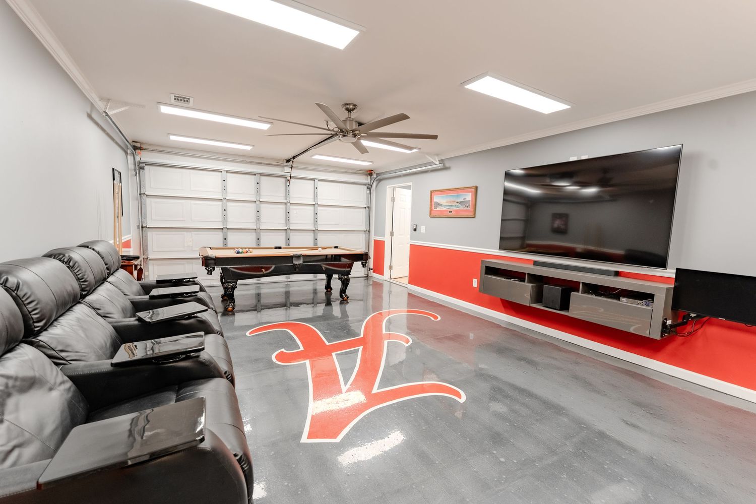 Modern fitness center with red accent walls features multiple exercise machines and equipment in a clean, well-lit space.