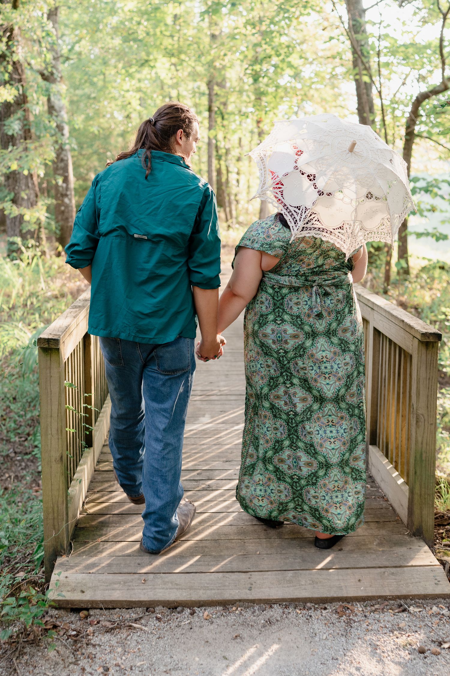 A sequence of romantic moments on a wooden boardwalk in a lush forest setting.