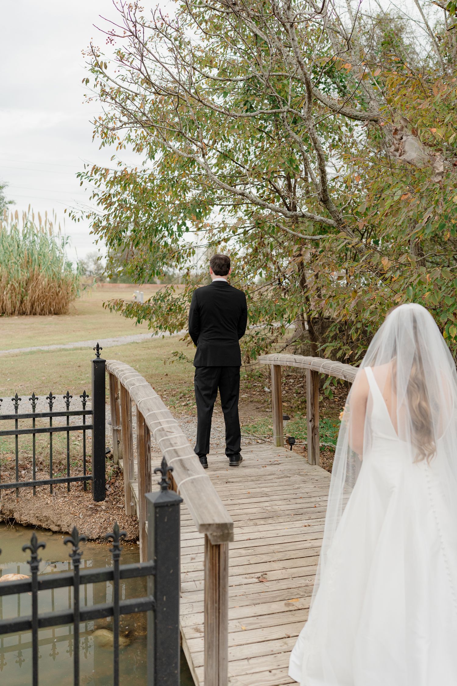 A sequence of wedding photos showing a first look moment on a wooden boardwalk surrounded by autumn trees.