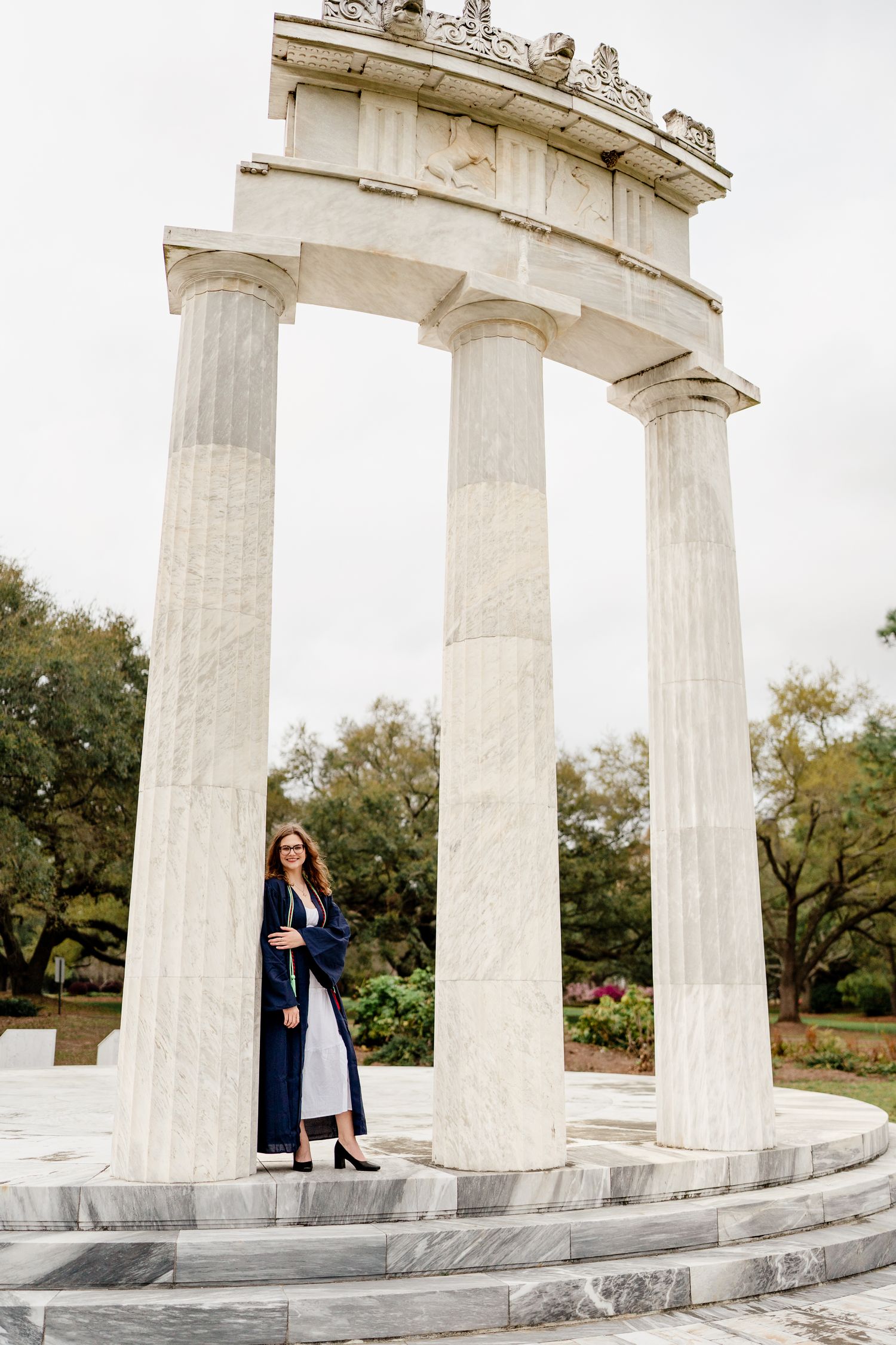 Three connected photos show a couple posing between white marble columns at an ancient Greek-style monument.
