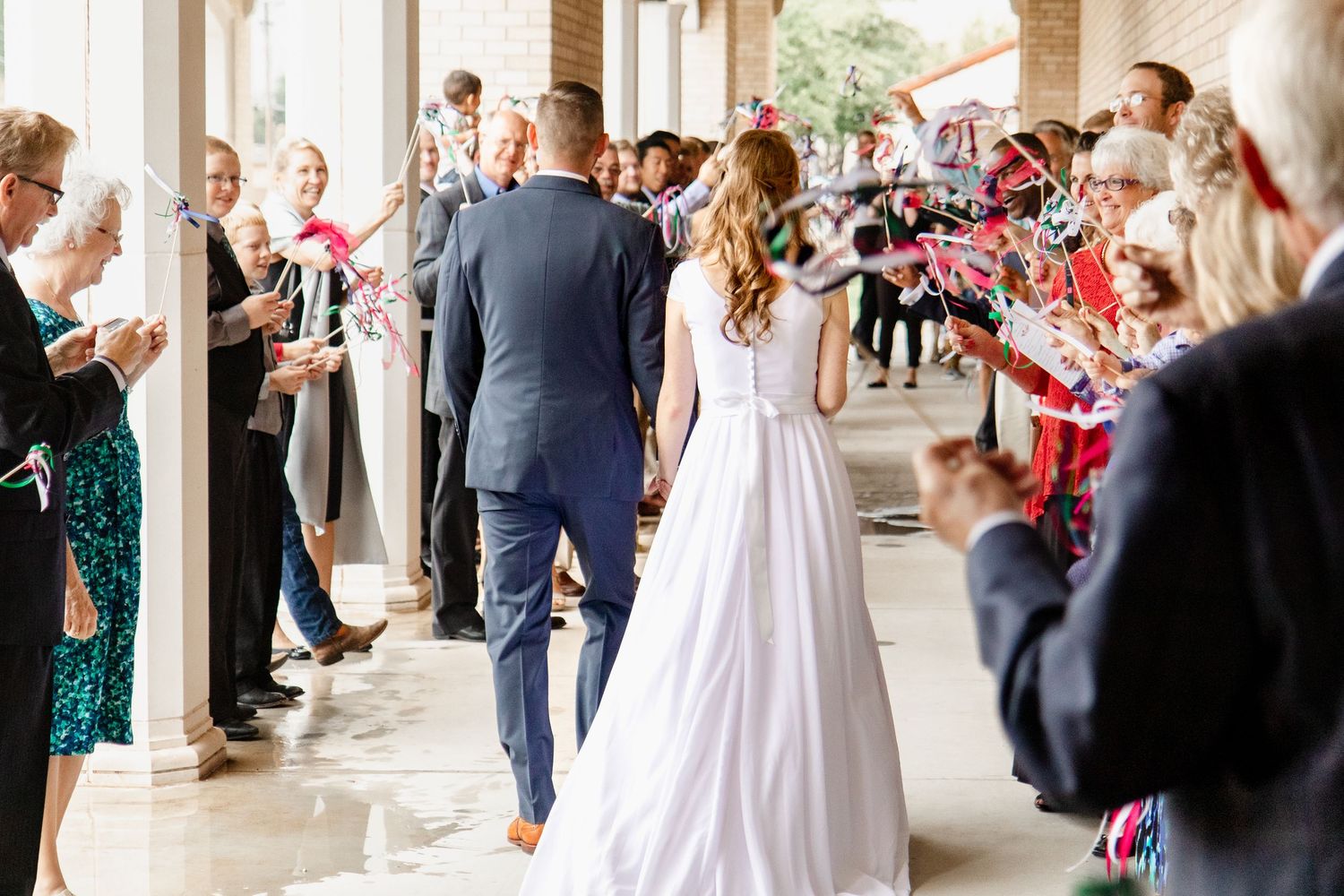 People celebrate at a festive indoor event with ornate columns and decorative elements.