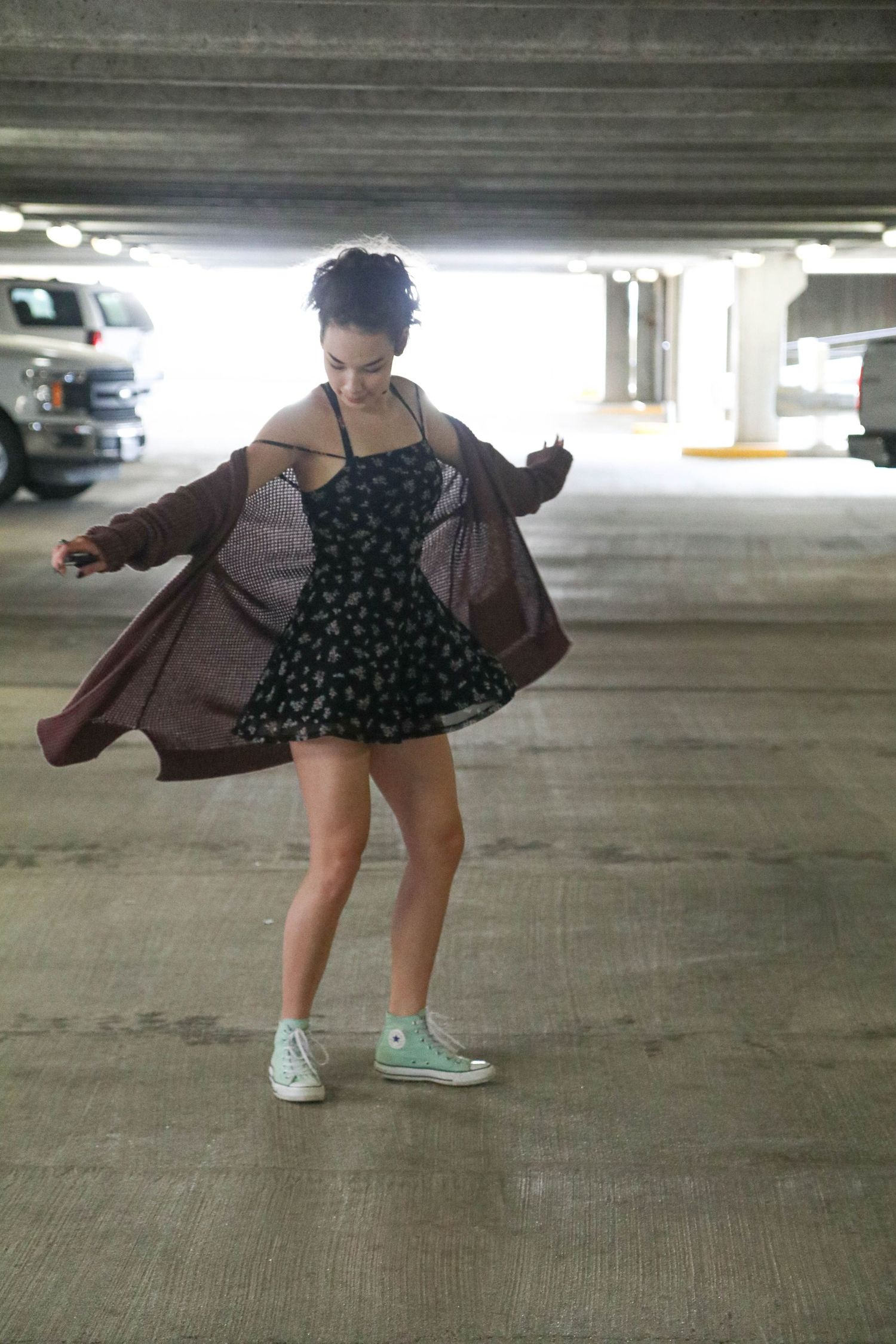 Dynamic movement shot in parking garage with flowy clothing motion.