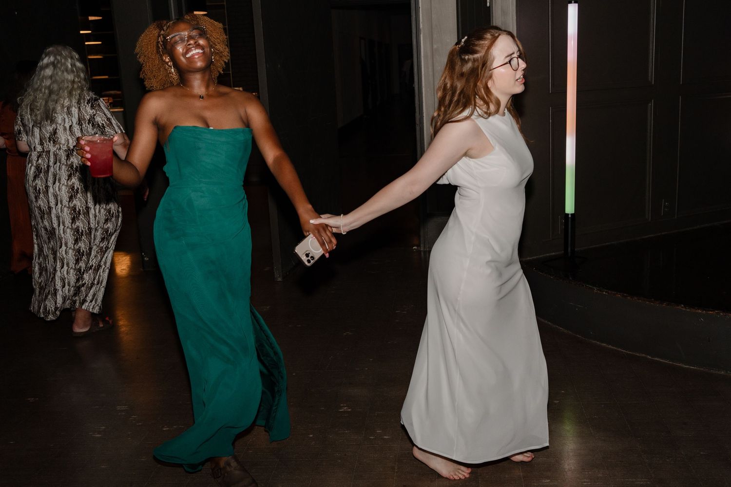 Two guests dancing and having fun at a nighttime celebration.