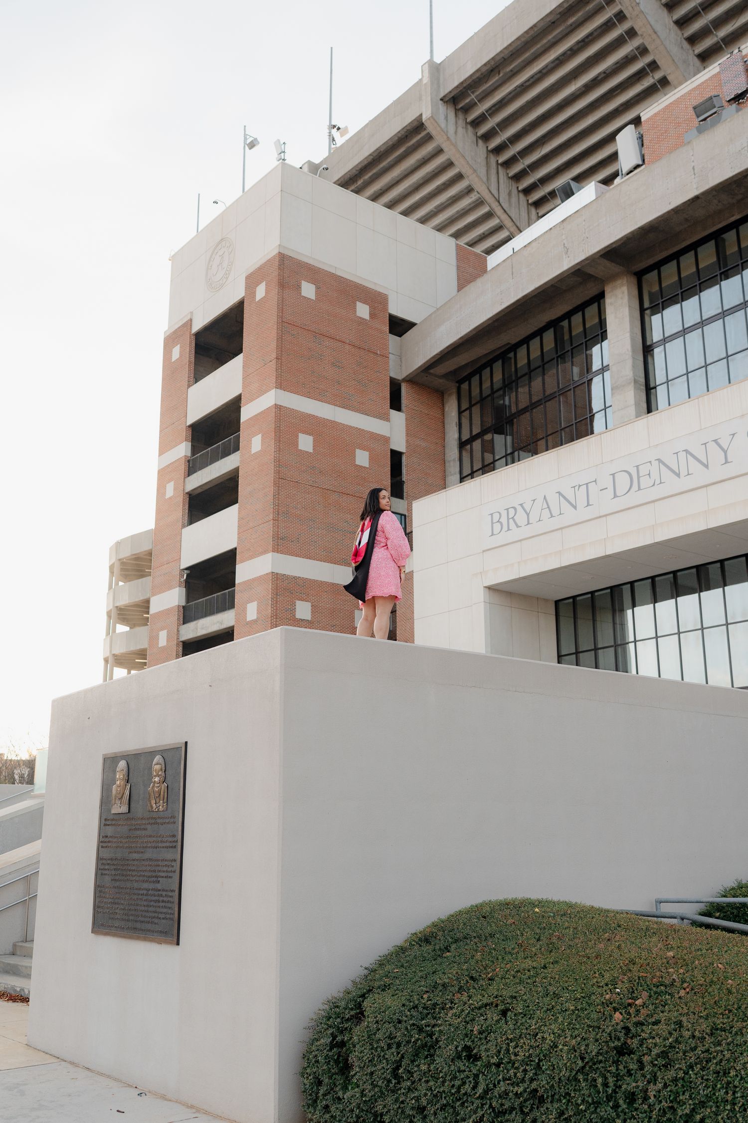 Exterior view of Bryant-Denny Stadium with modern architecture and signage visible on the facade.