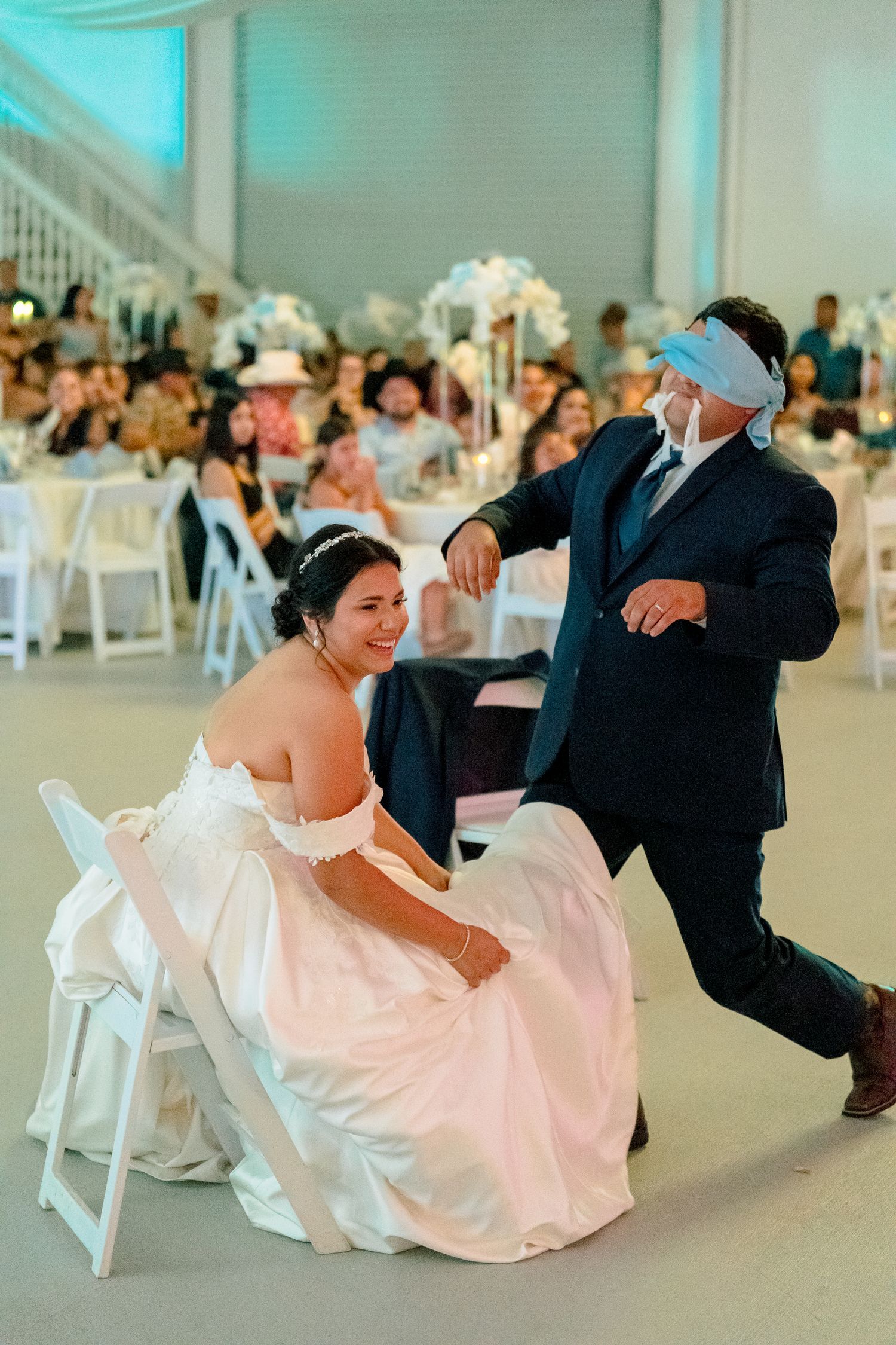 Wedding guests dancing and having fun on the dance floor at a reception.