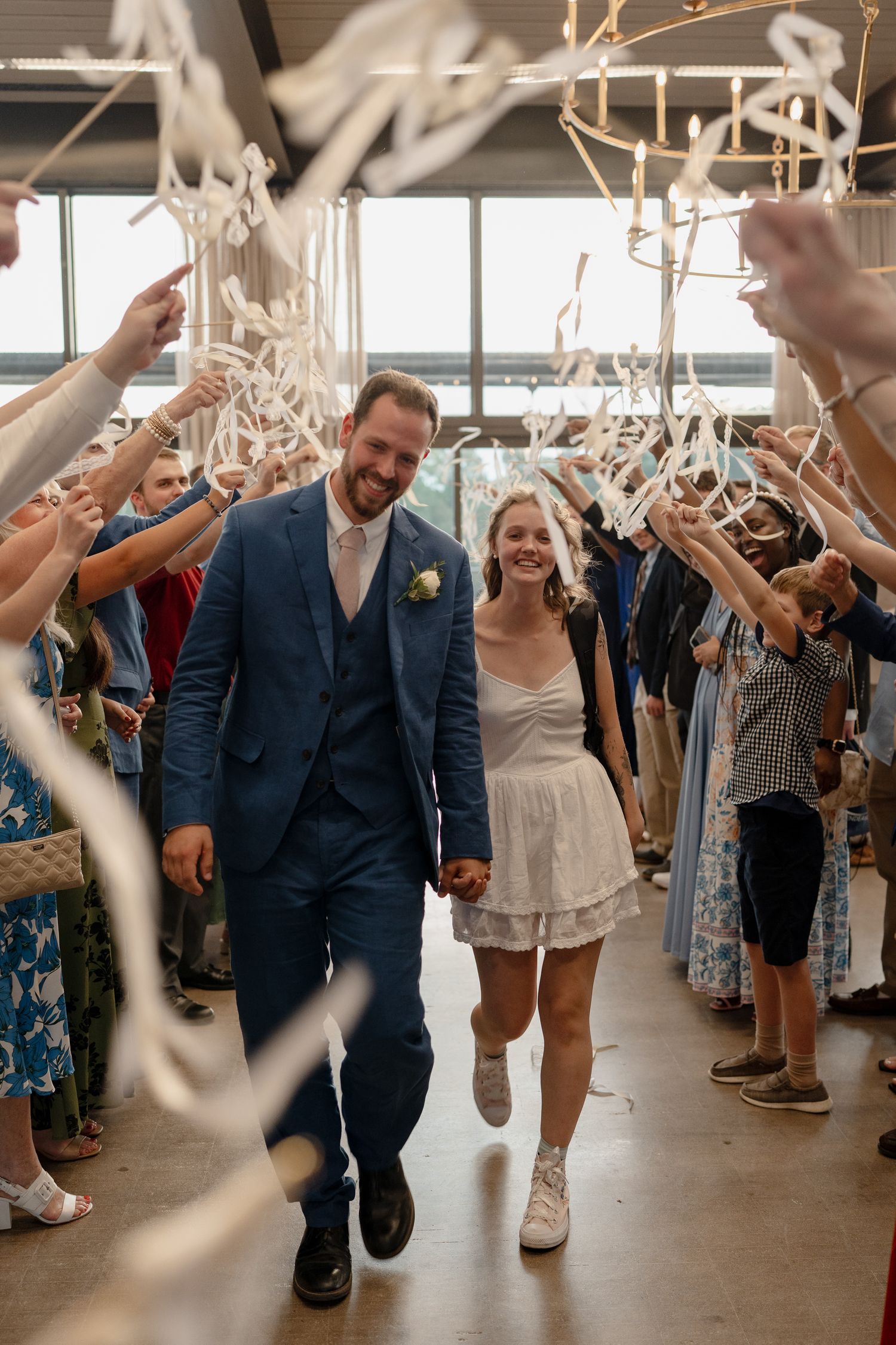 A couple walks through a celebratory sparkler exit at their wedding reception.