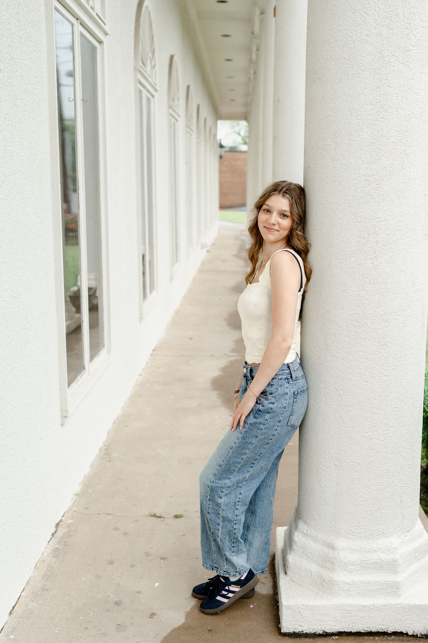 Architectural photoshoot featuring white pillars and natural lighting.