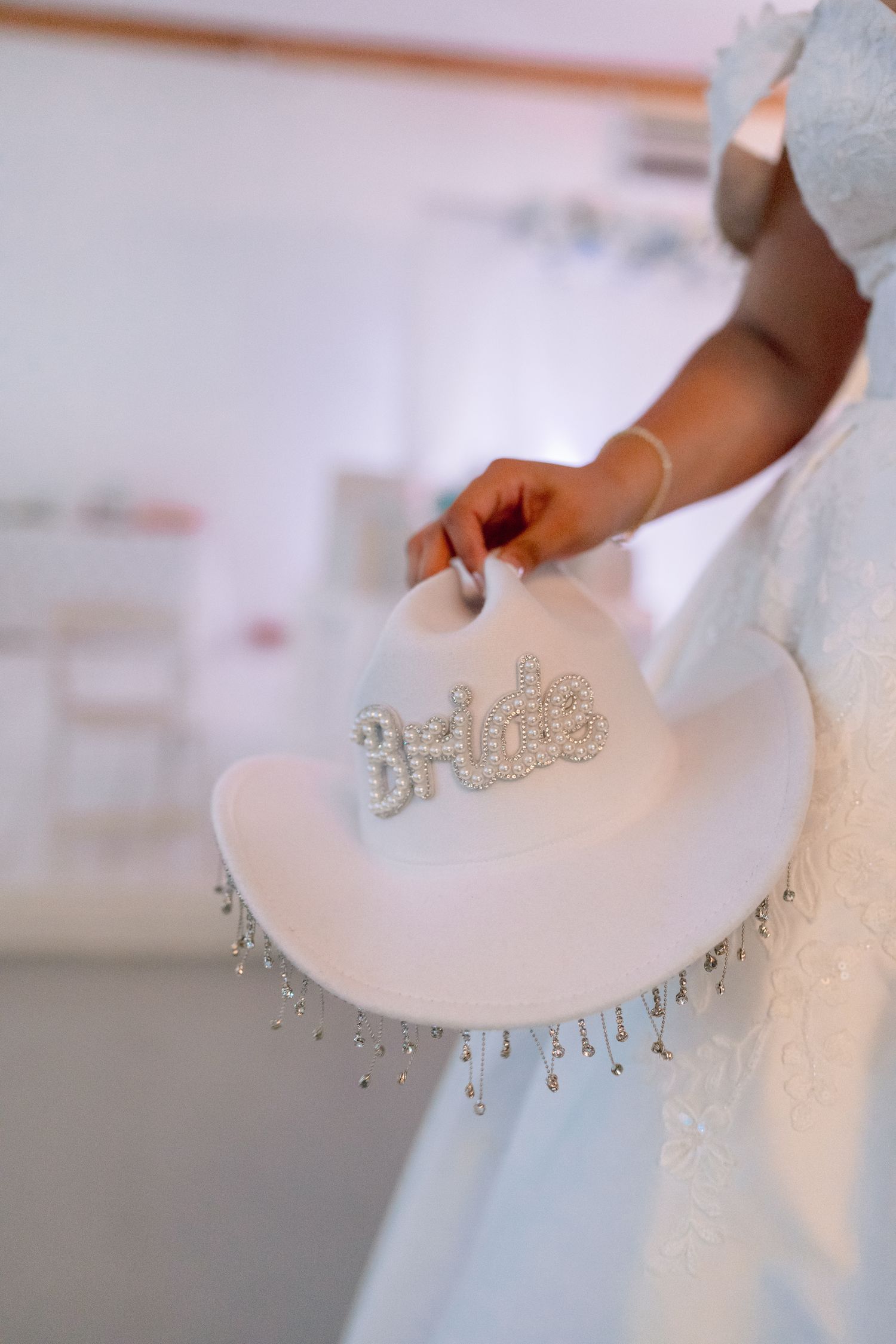 Close-up details of crystal embellishments on a white wedding dress.