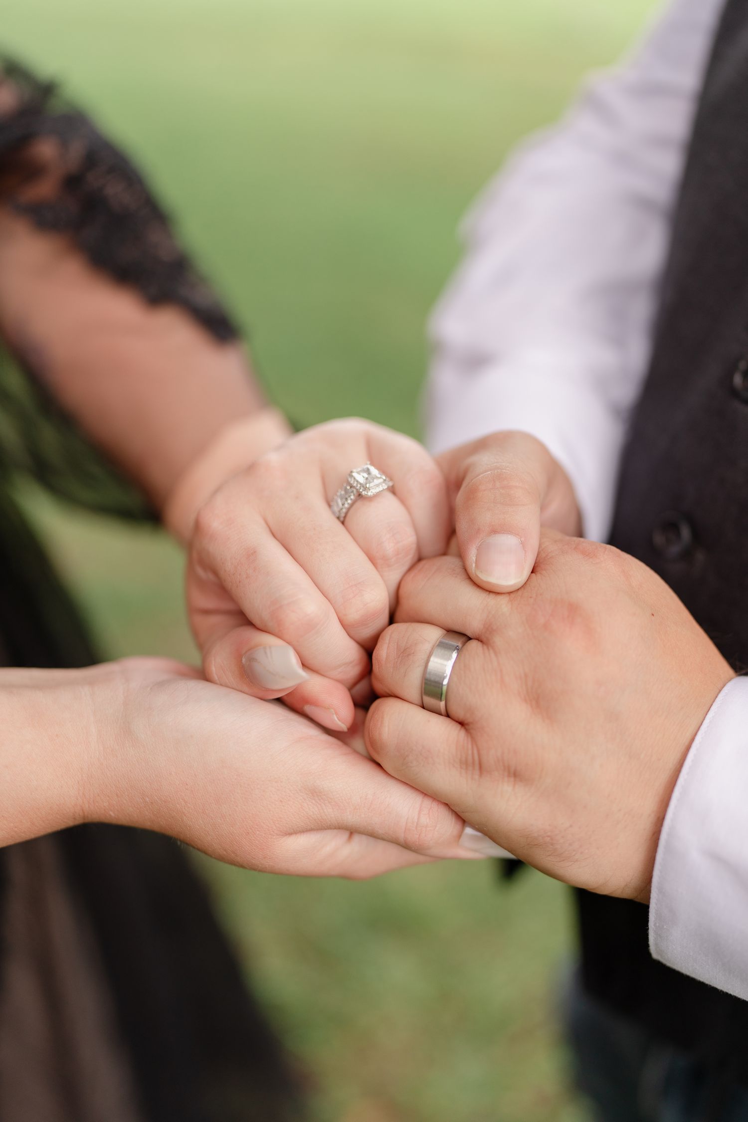 Close-up shots of hands displaying wedding rings against an outdoor background.