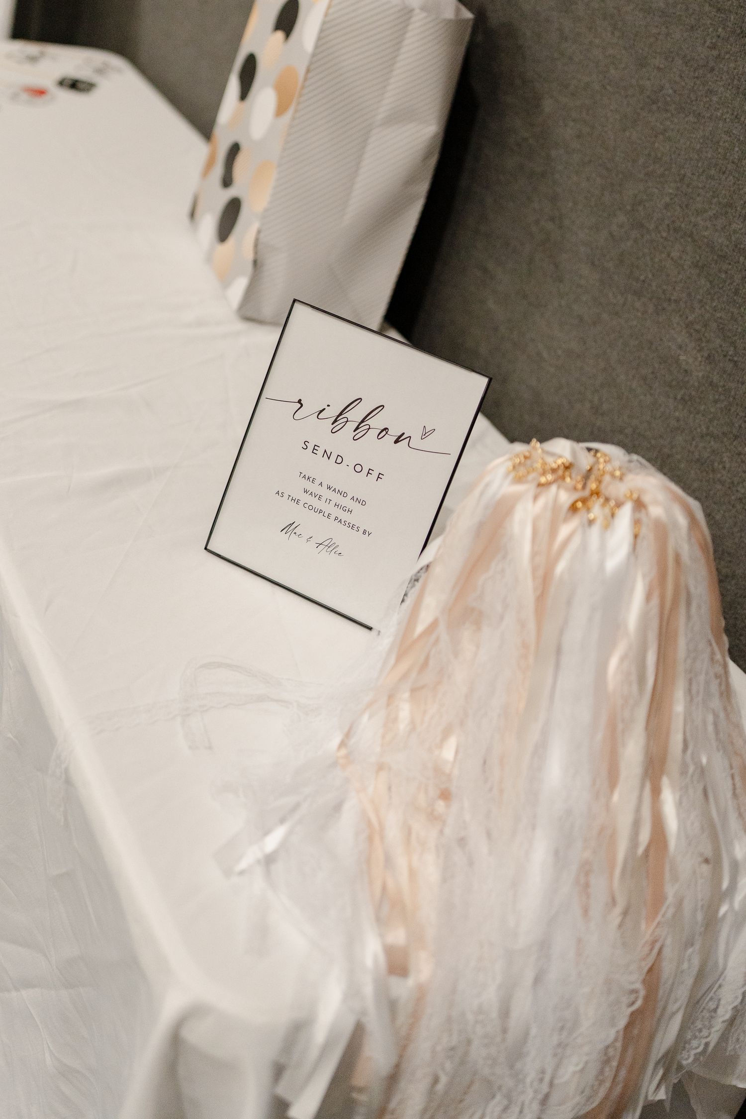 Wedding seating cards and place settings wrapped in protective clear plastic.