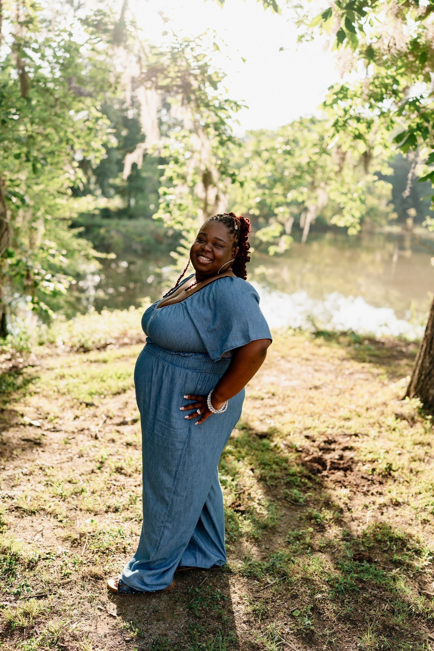 Candid moments captured in blue outfits during a sunny outdoor family photo session.