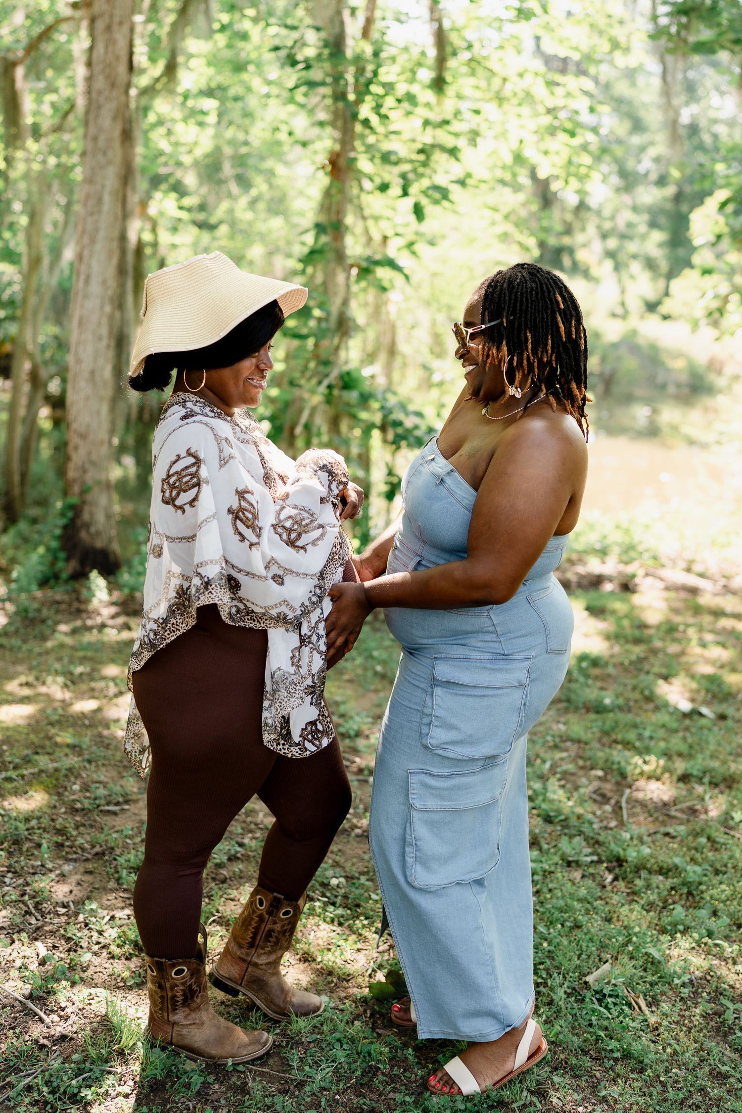 Two people share a joyful moment together in a wooded setting, wearing casual summer attire.