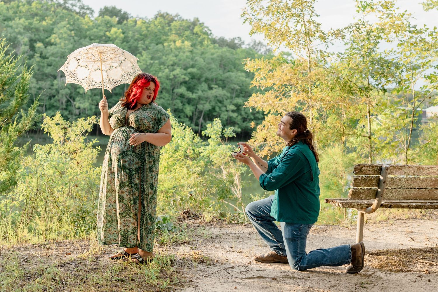 A romantic outdoor autumn photoshoot with a couple under an umbrella in a park setting.