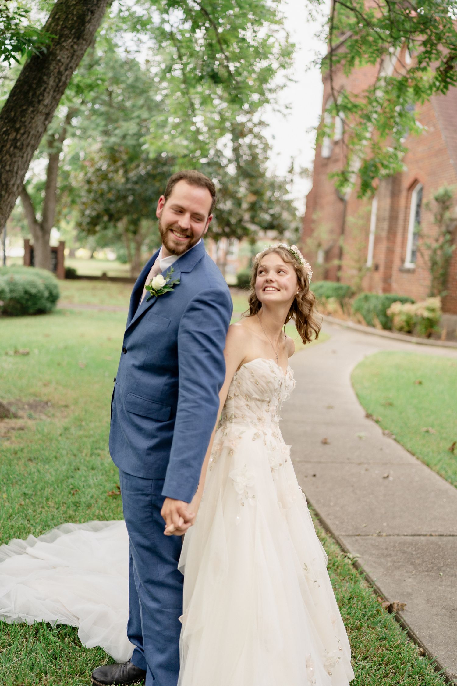 A joyful couple shares a candid moment together outdoors during their wedding photoshoot.